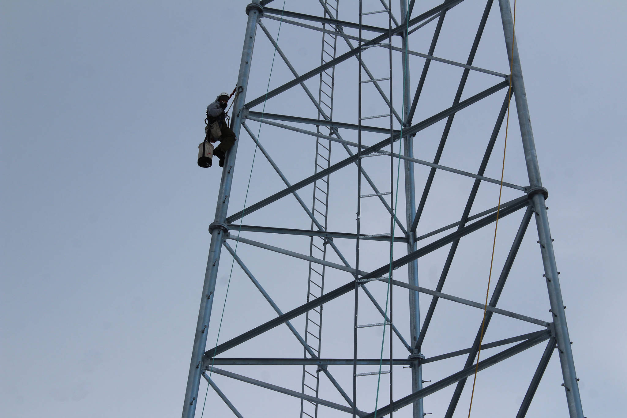 Billy Adamson scales a communications tower on Thursday, Jan. 7 in Nikiski, Alaska. (Ashlyn O’Hara/Peninsula Clarion)