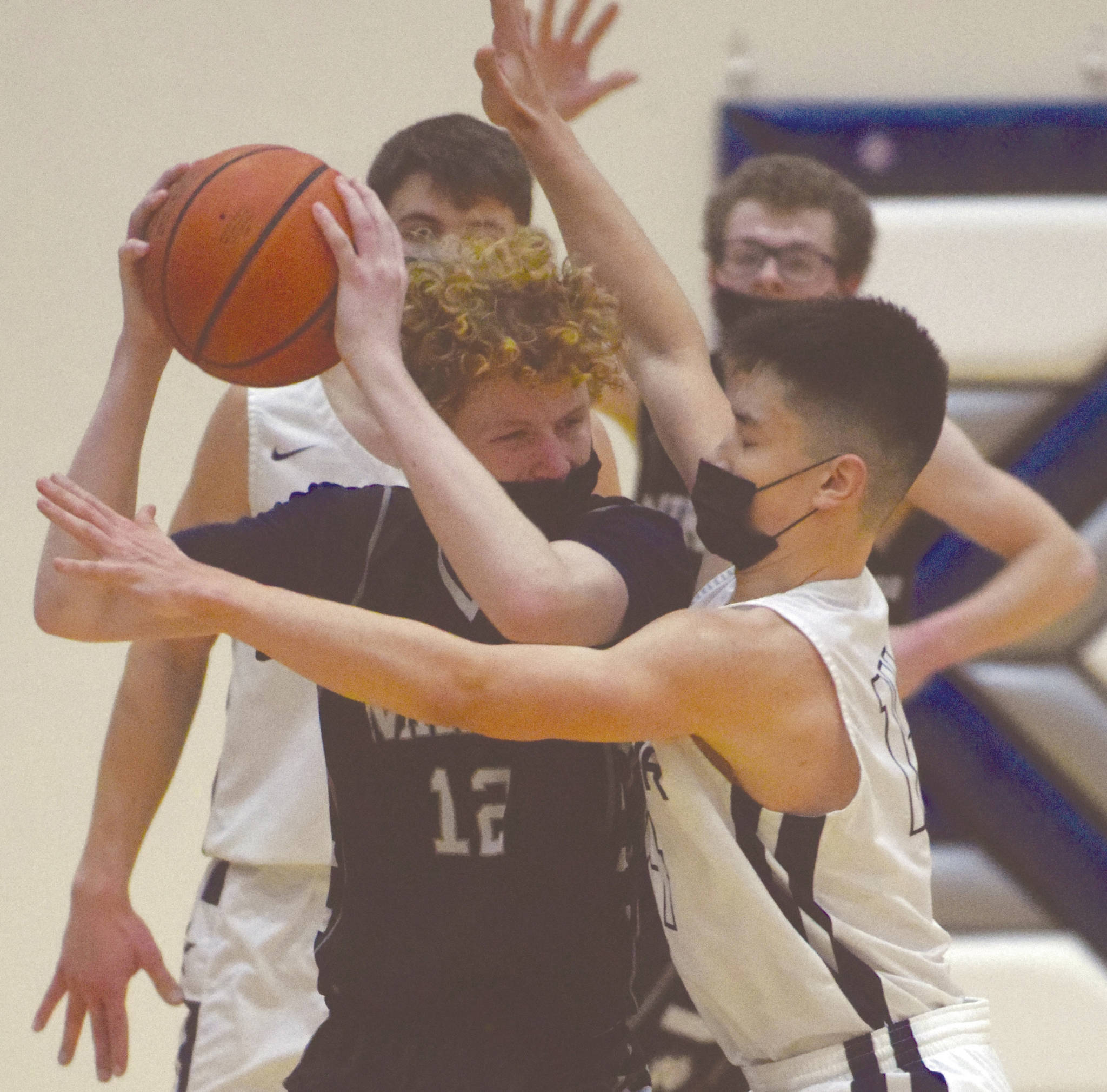 Nikiskis Brady Bostic faces pressure from Soldotnas Daniel McRorie on Saturday, Feb. 13, 2021, at Soldotna High School in Soldotna, Alaska. (Photo by Jeff Helminiak/Peninsula Clarion)
