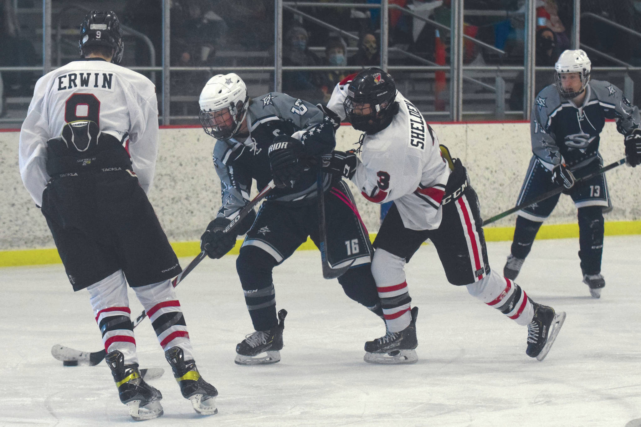 Soldotna's Dylan Walton attacks Kenai's Central's Hunter Erwin and Daniel Shelden on Saturday, Feb. 13, 2021, at the Kenai Multi-Purpose Facility in Kenai, Alaska. (Photo by Jeff Helminiak/Peninsula Clarion)