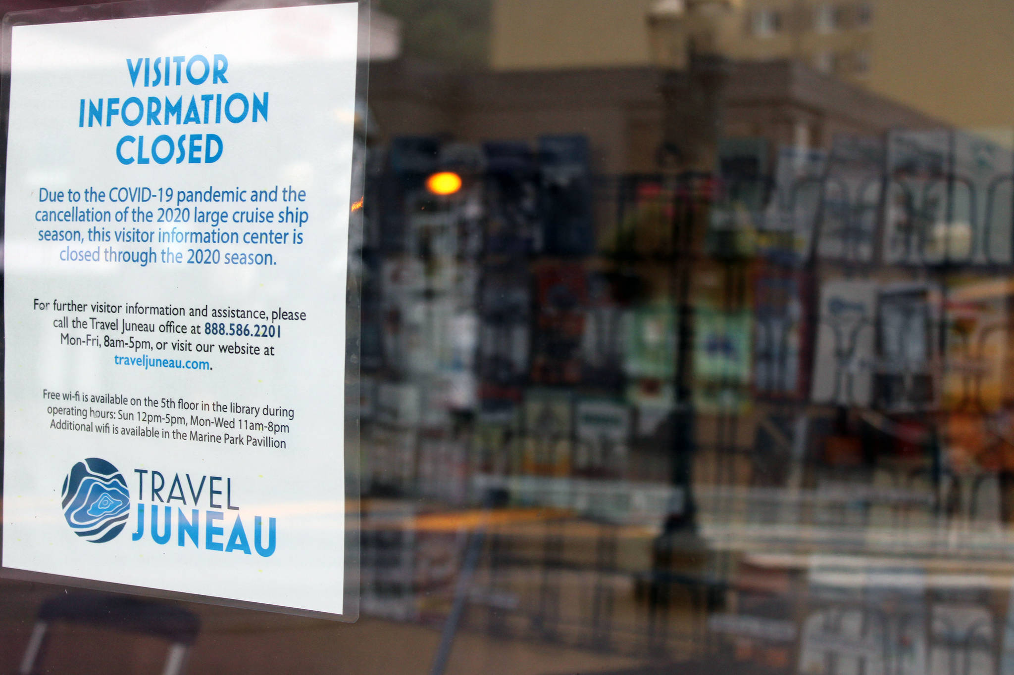 A sign posted by Travel Juneau notes the pamphlet-filled visitor’s center kiosk is closed because of the pandemic. The center, located near the downtown library, opened in May 2019 during Infrastructure Week. (Ben Hohenstatt / Juneau Empire File)