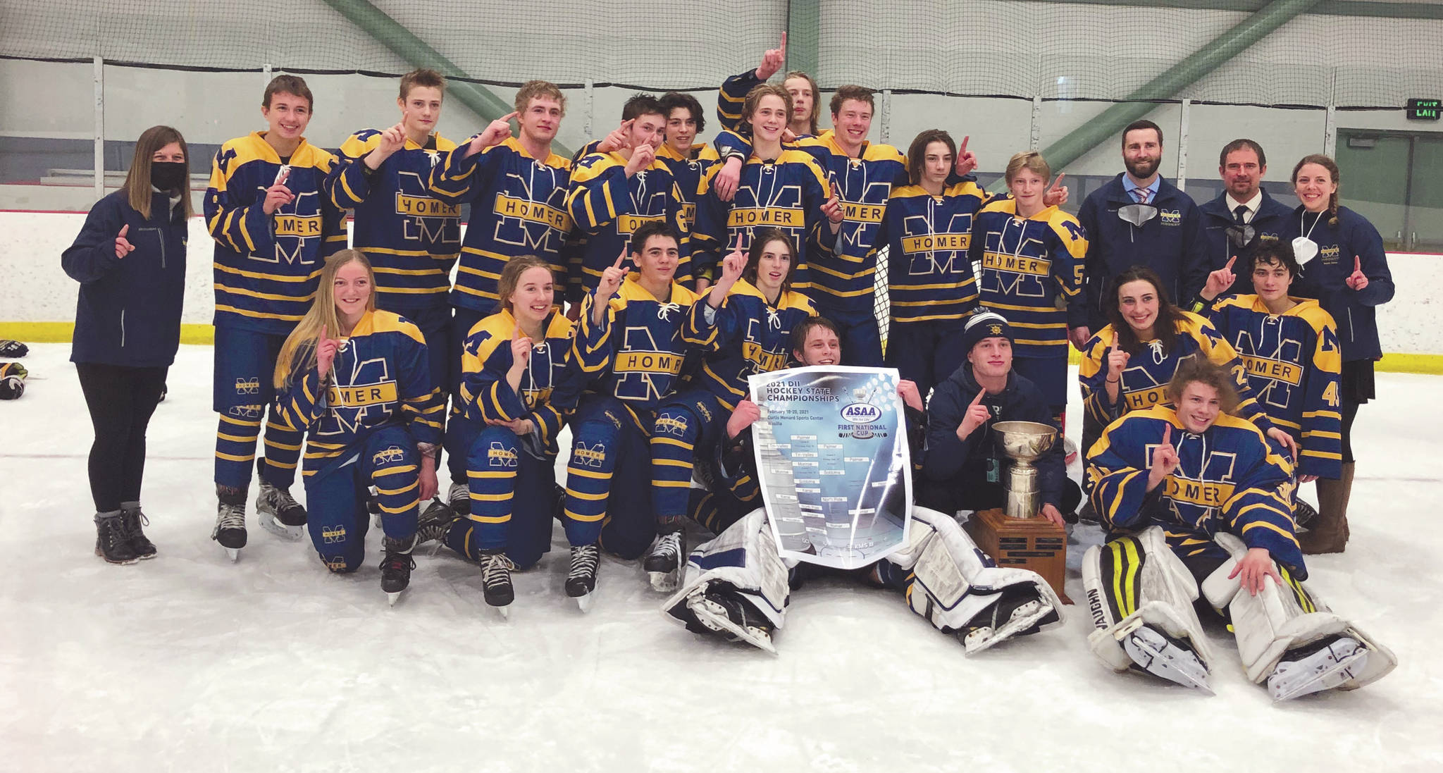 The Homer hockey team celebrates the Division II state championship Saturday, Feb. 20, 2021, at the Curtis Mendard Sports Complex in Wasilla, Alaska. (Photo by Tim Rockey/Frontiersman)