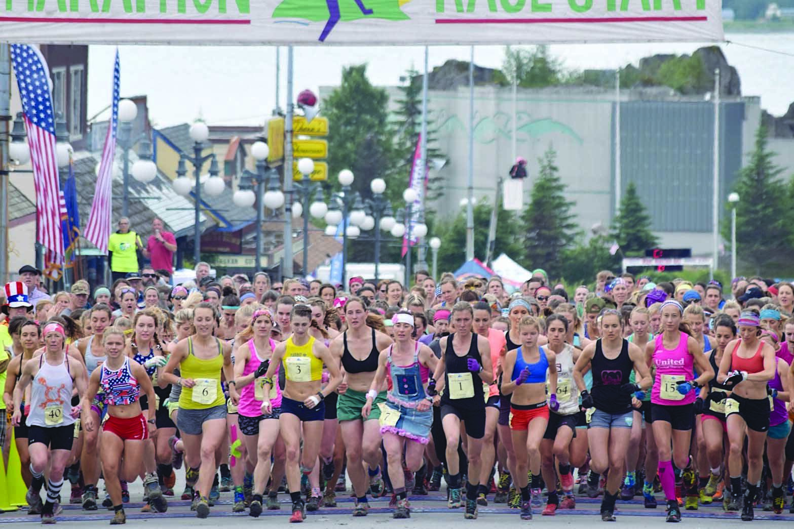 The women’s field takes to the course Tuesday, July 4, 2017, at the Mount Marathon Race in Seward, Alaska. Eventual winner Allie Ostrander is to the right of Christy Marvin (1). (Photo by Jeff Helminiak/Peninsula Clarion)