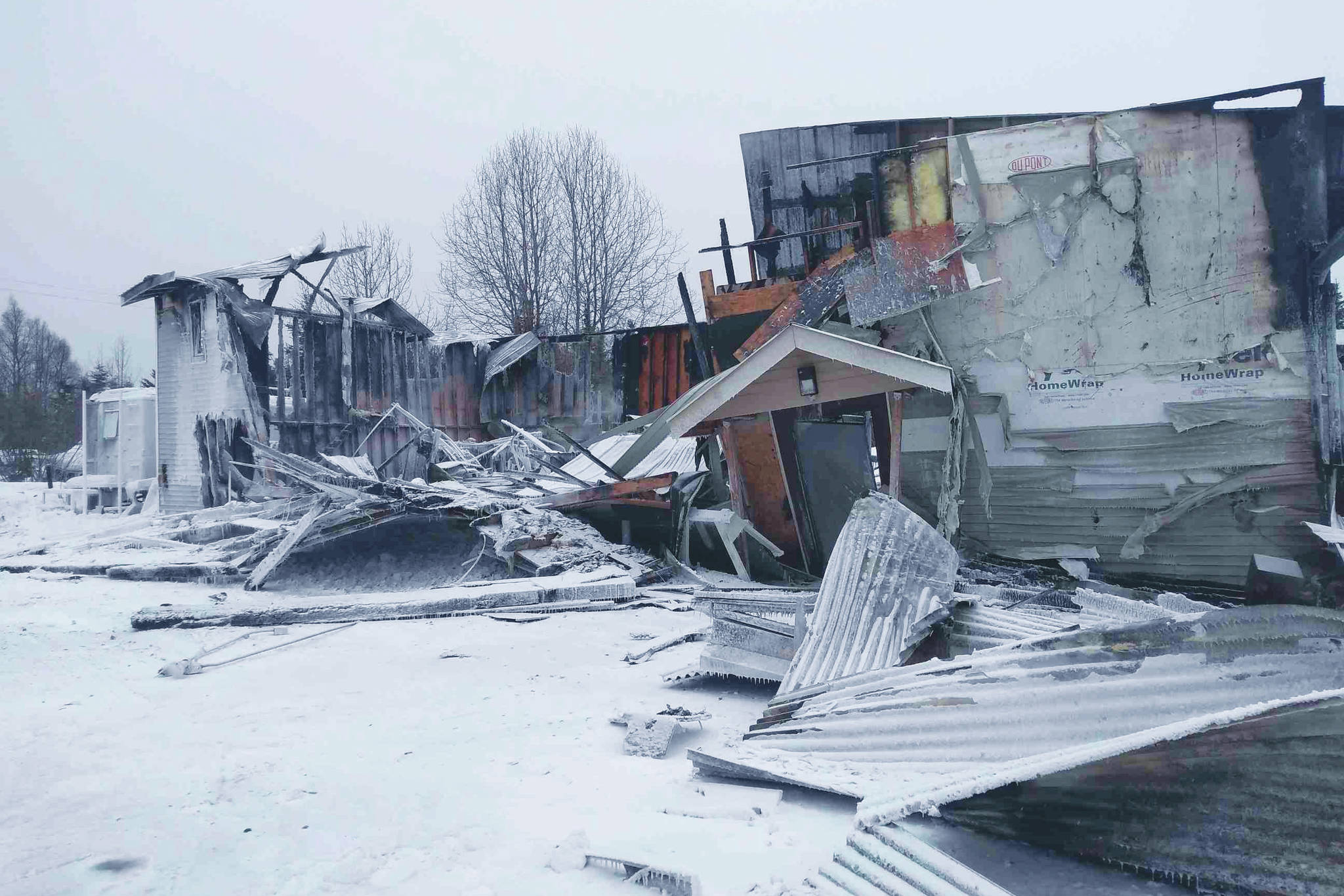The collapsed remnants of the Triumvirate Theatre can be seen on Saturday, Feb. 20, 2021 in Nikiski, Alaska. The building burned down in an early morning fire on Saturday. (Photo courtesy of Joe Rizzo)