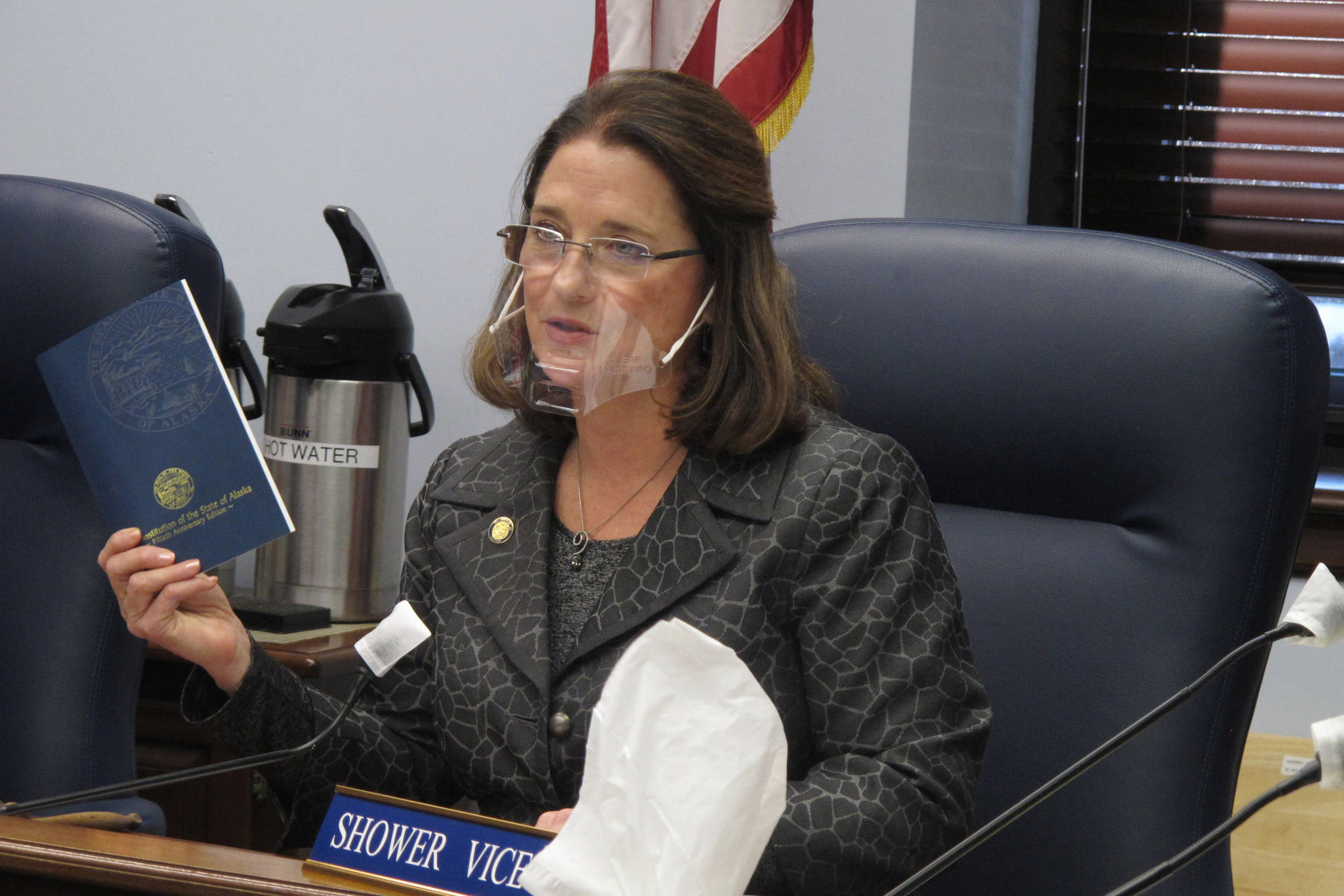 Alaska state Sen. Lora Reinbold, an Eagle River Republican, holds a copy of the Alaska Constitution during a committee hearing on Wednesday, Jan. 27, 2021, in Juneau, Alaska. Gov. Mike Dunleavy, a Republican, sent Reinbold a letter on Feb. 18, 2021, saying she has used her position to “misrepresent” the state’s COVID-19 response. Reinbold said the letter was “full of baseless accusations and complaints.” (AP Photo/Becky Bohrer)