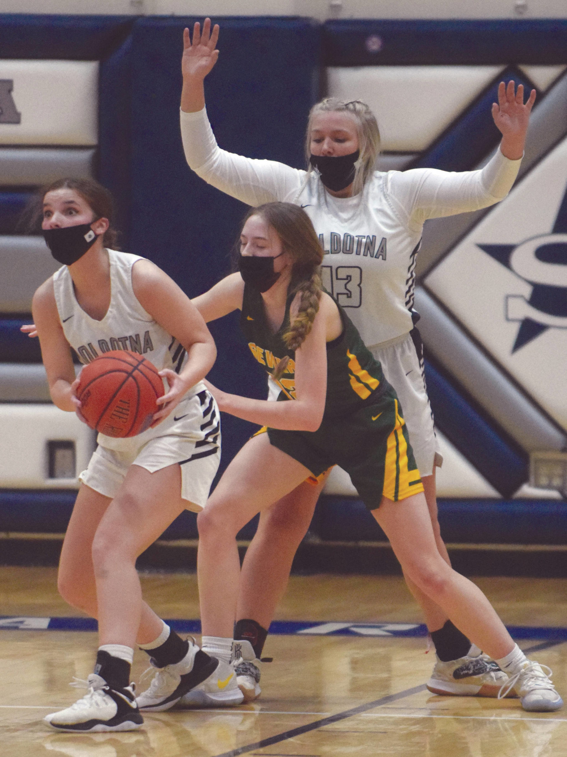 Soldotna’s Morgan Bouschor looks for an outlet pass under pressure from Seward’s Shelby Sieminski as Soldotna’s Taylor Edwards looks on at Soldotna High School on Tuesday, Feb. 23, 2021, in Soldotna, Alaska. (Photo by Jeff Helminiak/Peninsula Clarion)