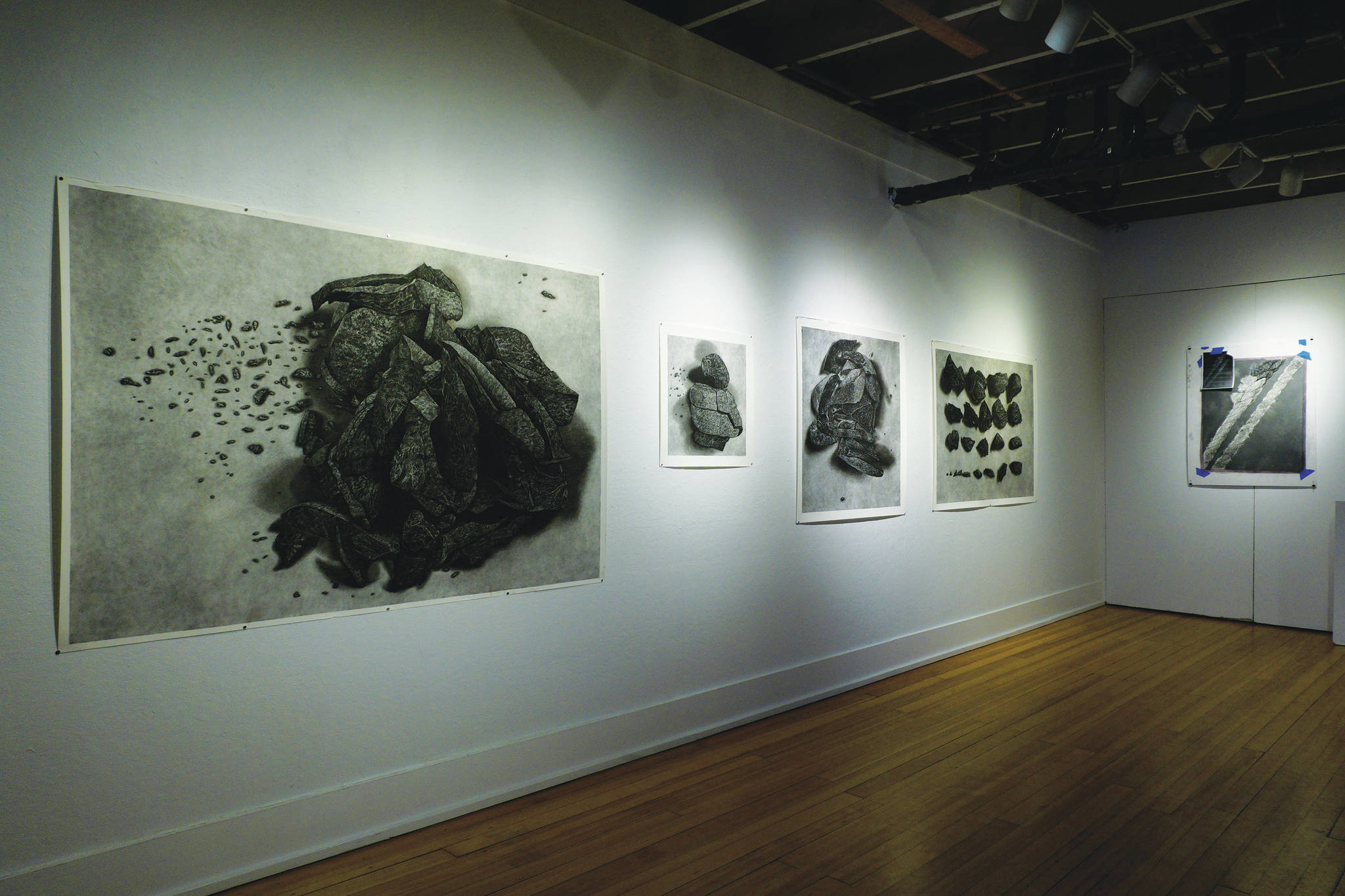 Bunnell Street Arts Center Artist in Residence Nina Elder’s work is displayed on Thursday, Feb. 11, 2021, at the gallery in Homer, Alaska. At left are pieces from her series, “It Will Not Be the Same, But It Might Be Beautiful,” drawings of puzzle stones collected in the area near McCarthy, Alaska. At right is a drawing of frayed rope, part of her focus during her residency. (Photo by Michael Armstrong/Homer News)