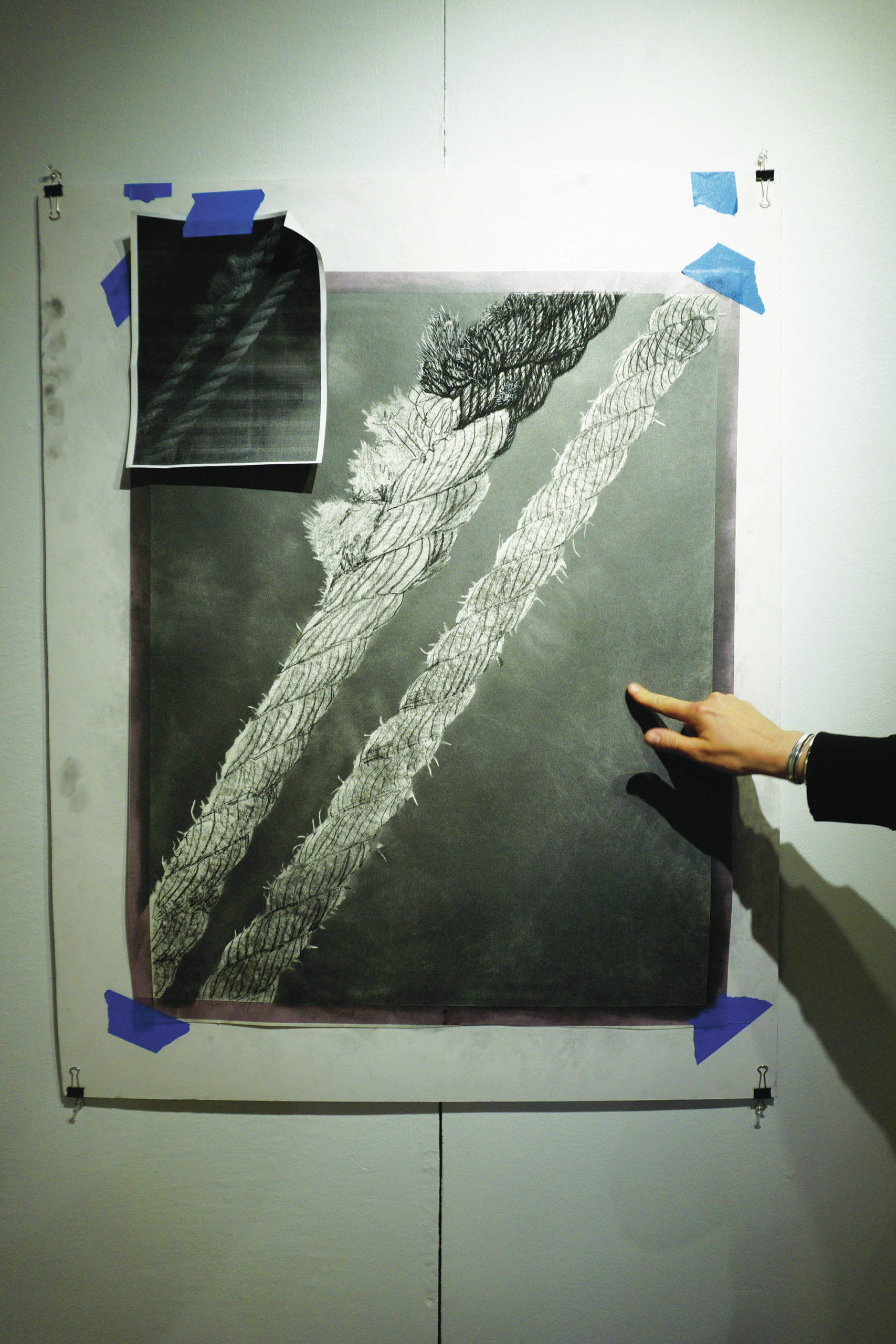 Bunnell Street Arts Center Artist in Residence Nina Elder points to a drawing of frayed rope on Thursday, Feb. 11, 2021, at Bunnell Street Arts Center in Homer, Alaska. During her residency she will be drawing found objects like rope that people bring to her. (Photo by Michael Armstrong/Homer News)