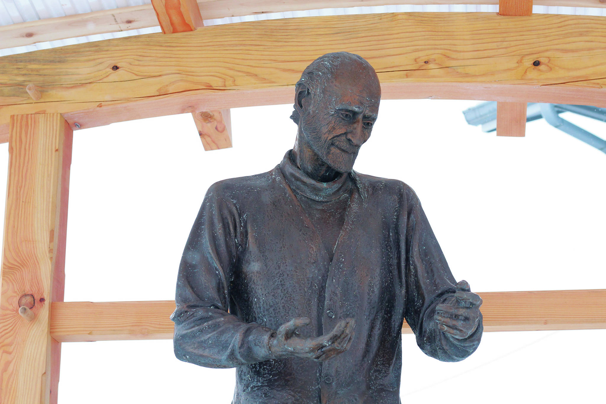 A statue of Brother Asaiah rests under a protective wooden structure on Thursday, Feb. 18, 2021 outside KBBI Public Radio in Homer, Alaska. (Photo by Megan Pacer/Homer News)