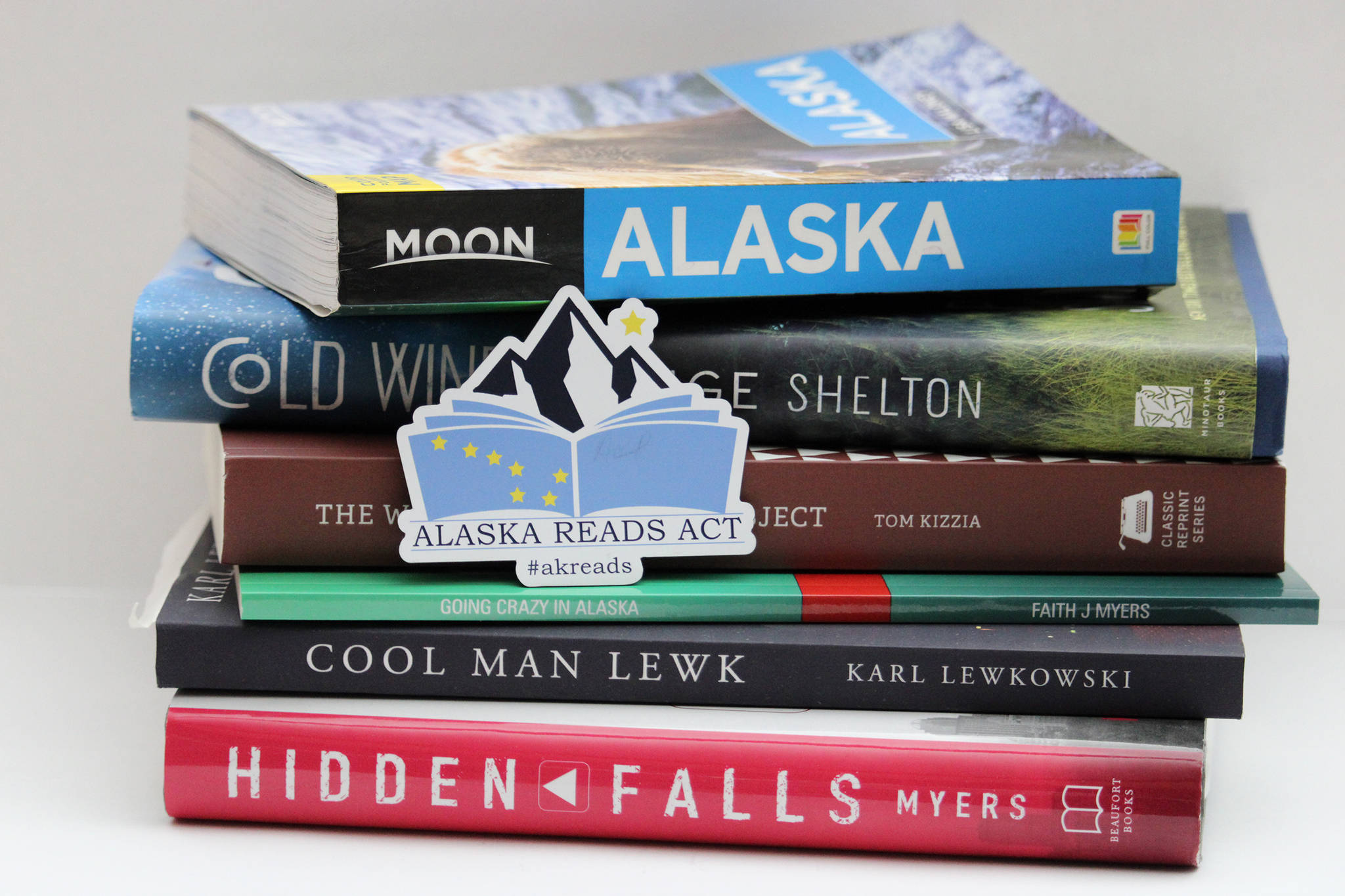A magnet promoting the Alaska Reads Act released by the state last year sits atop a stack of Alaskan-authored and Alaska-centric books. A shortened session last year meant the bill, announced by Senate Minority Leader Tom Begich, D-Anchorage, and Gov. Mike Dunleavy, didn’t make it through the last Legislature. But there’s a new bill, nearly the same as the old bill, working its way through the Senate. (Ben Hohenstatt / Juneau Empire file)