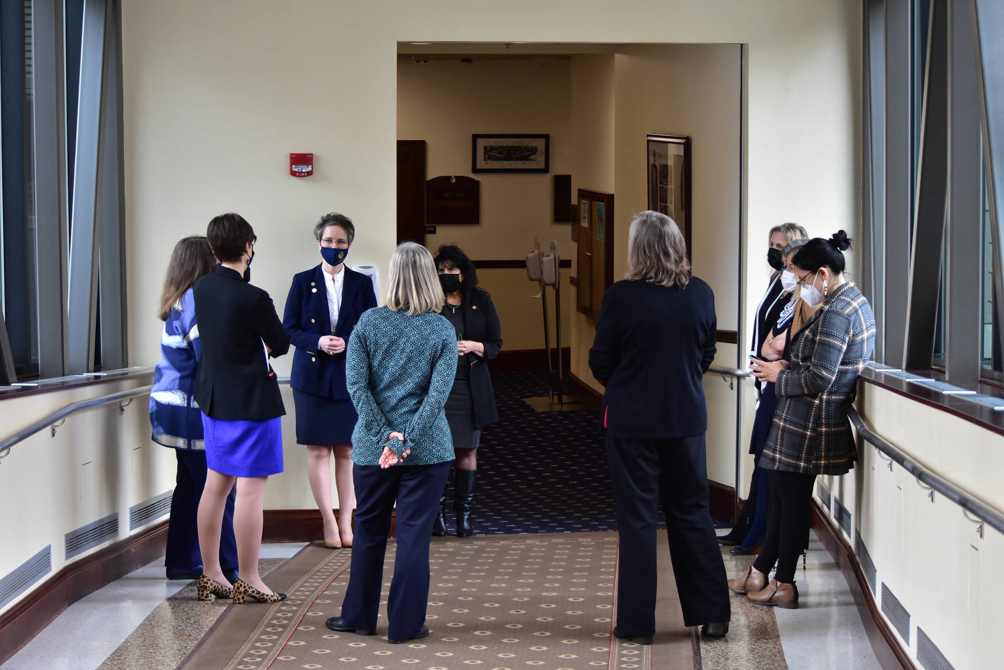 Women members of the Alaska House of Representatives from both parties meet in the hallway of the capitol Wednesday, March 3, 2021, to discuss a vote to condemn Rep. Zack Fields, D-Anchorage, for sexists comments he made on the floor the previous week. (Peter Segall / Juneau Empire)