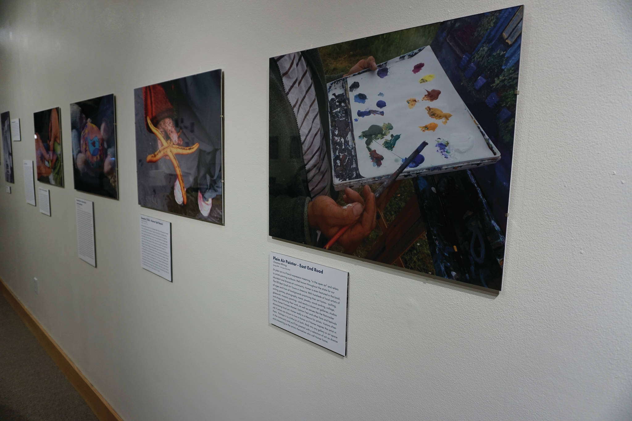 Chritina Whiting’s portraits focus on hands and not faces. They’re some of the works included in “Familiar Faces: Portrait of a Community,” on exhibit through May 2021 at the Pratt Museum in Homer, Alaska. (Photo by Michael Armstrong/Homer News)