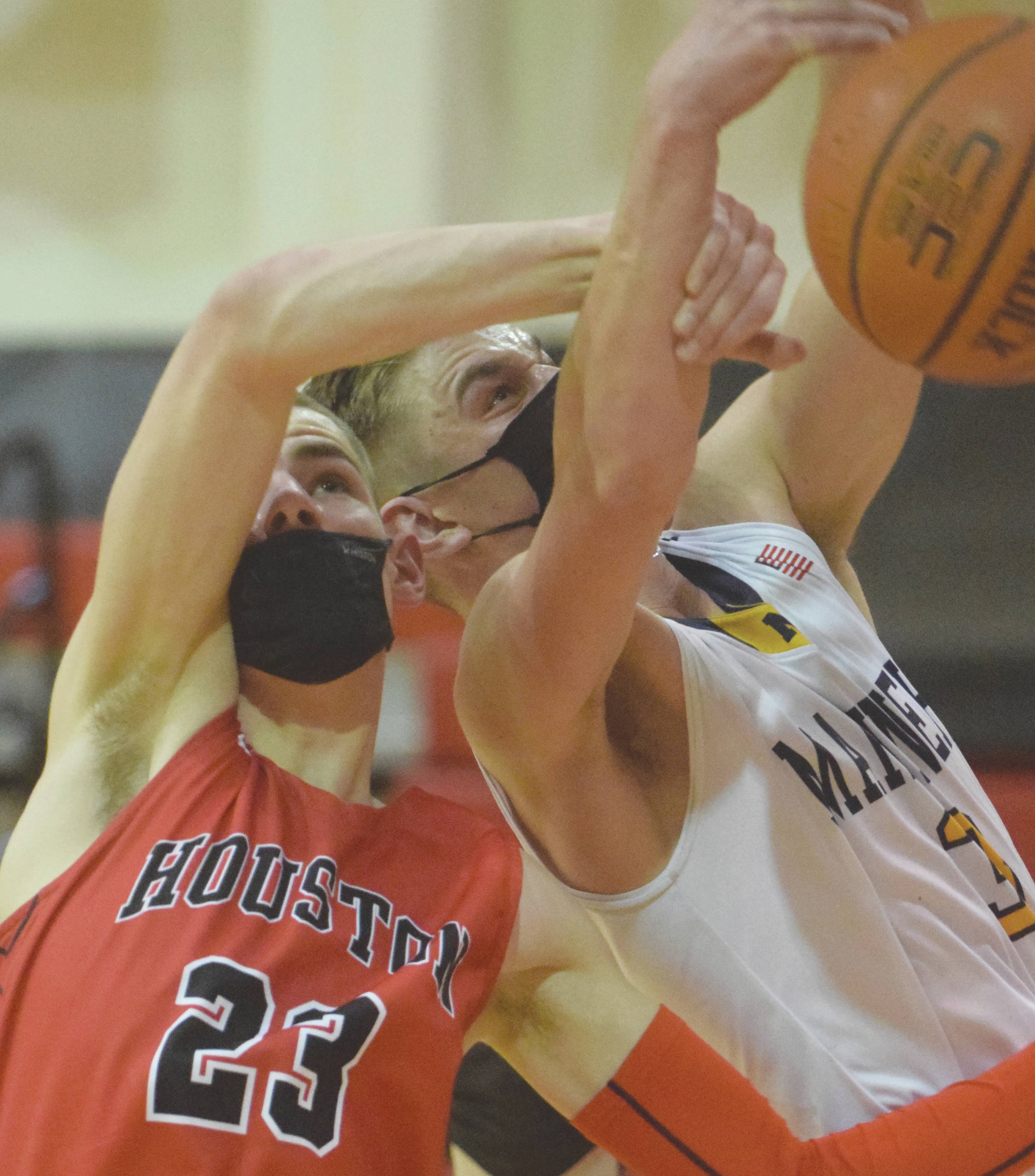 Houstons Hunter Jefferson and Homers Clayton Beachy battle for the rebound Saturday in the third-place game of the Southcentral Conference boys tournament at Kenai Central High School in Kenai. (Photo by Jeff Helminiak/Peninsula Clarion)