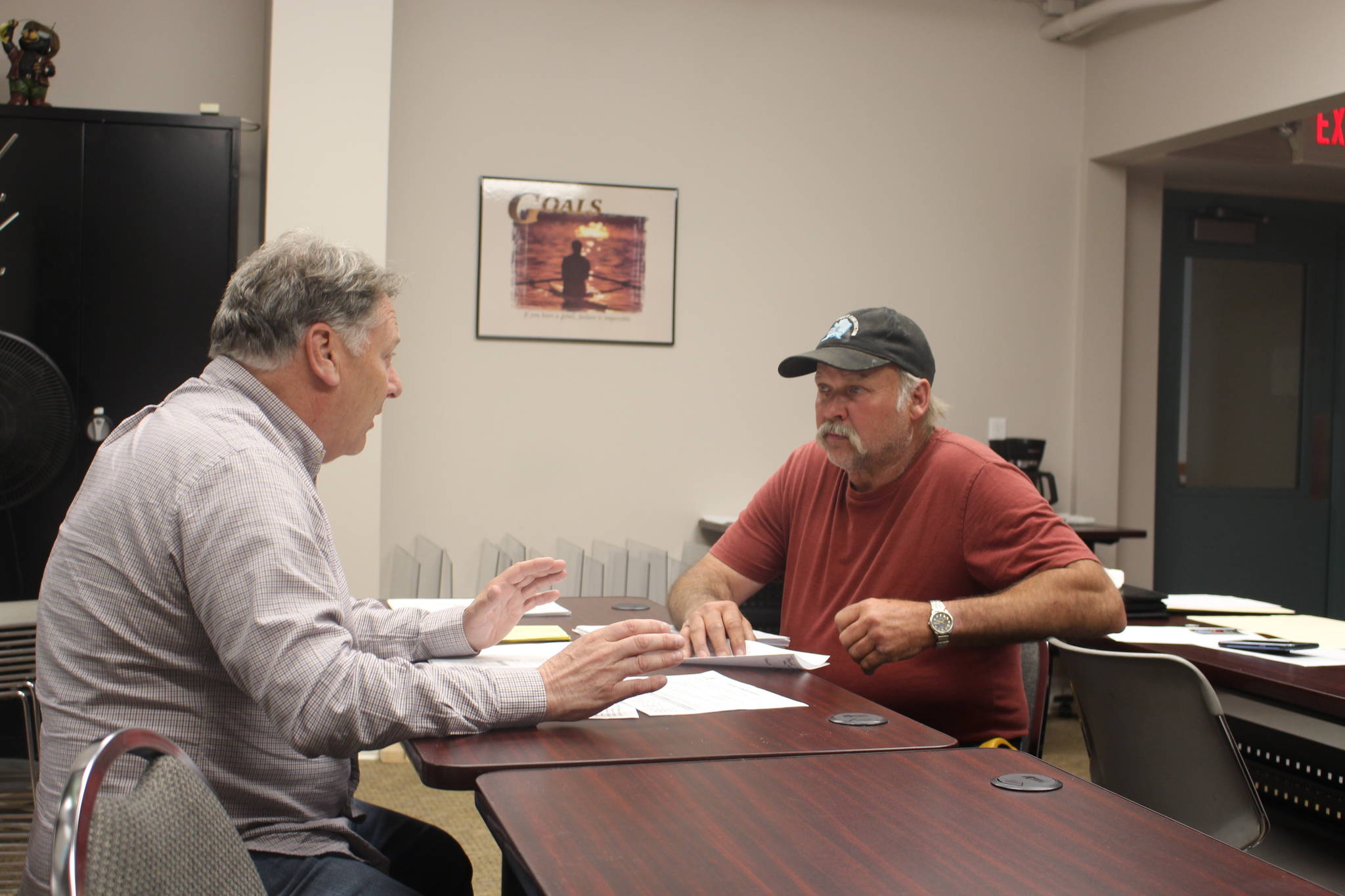 Tim Dillon, executive director of the Kenai Peninsula Economic Development District, helps Doug Weaver, owner of Northern Superior Construction, apply for an AK CARES grant through Credit Union 1 at the KPEDD office in Kenai, Alaska on July 1, 2020. (Photo by Brian Mazurek/Peninsula Clarion)