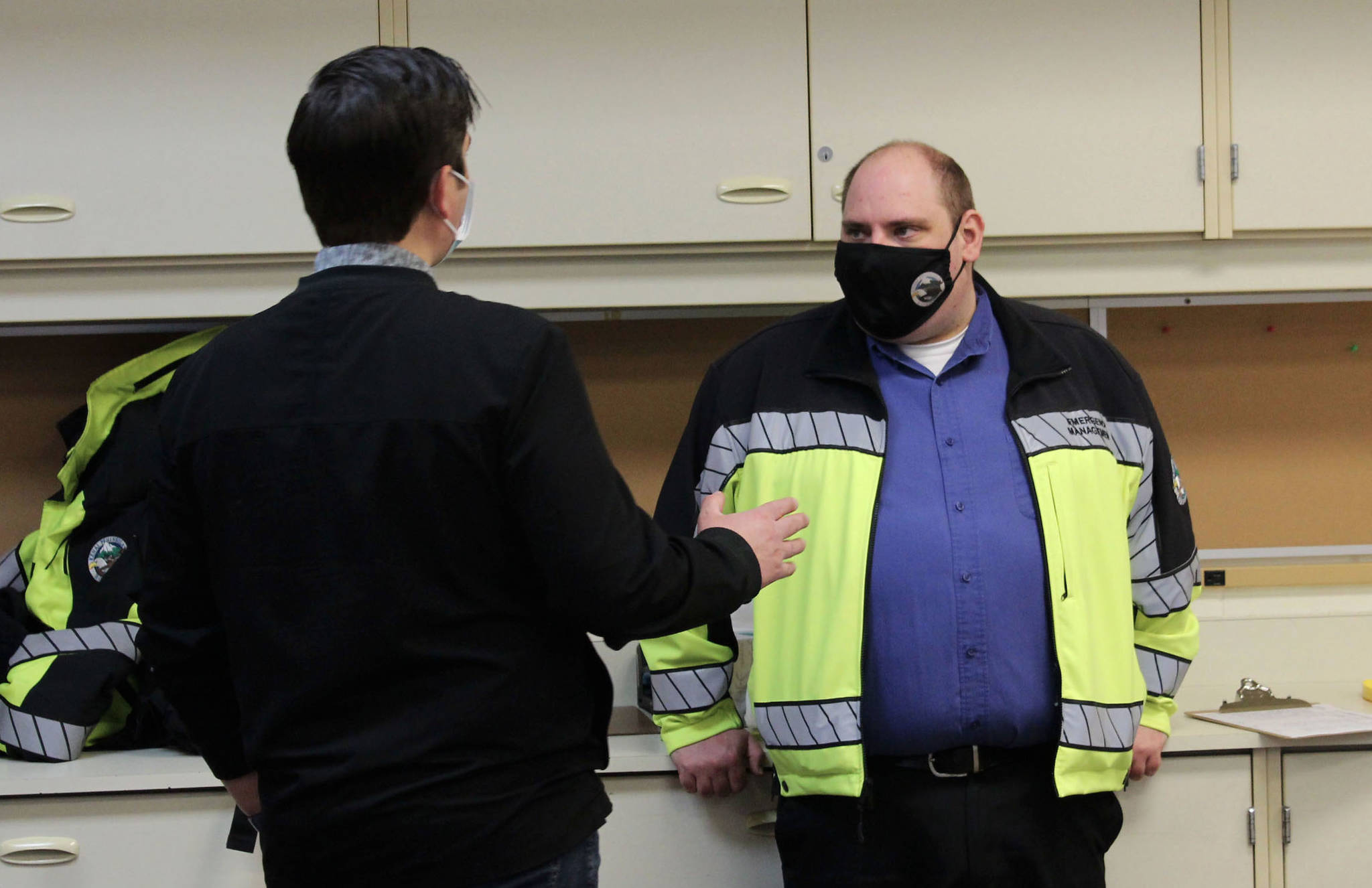 Soldotna Professional Pharmacy owner Justin Ruffridge (left) speaks to Dan Nelson, emergency manager of the Kenai Peninsula Borough Office of Emergency Management, at a COVID-19 vaccine clinic on Friday, Feb. 26, 2021 in Soldotna, Alaska. OEM has partnered with the local pharmacy to host large vaccination clinics on the peninsula. (Photo by Ashlyn O’Hara/Peninsula Clarion)