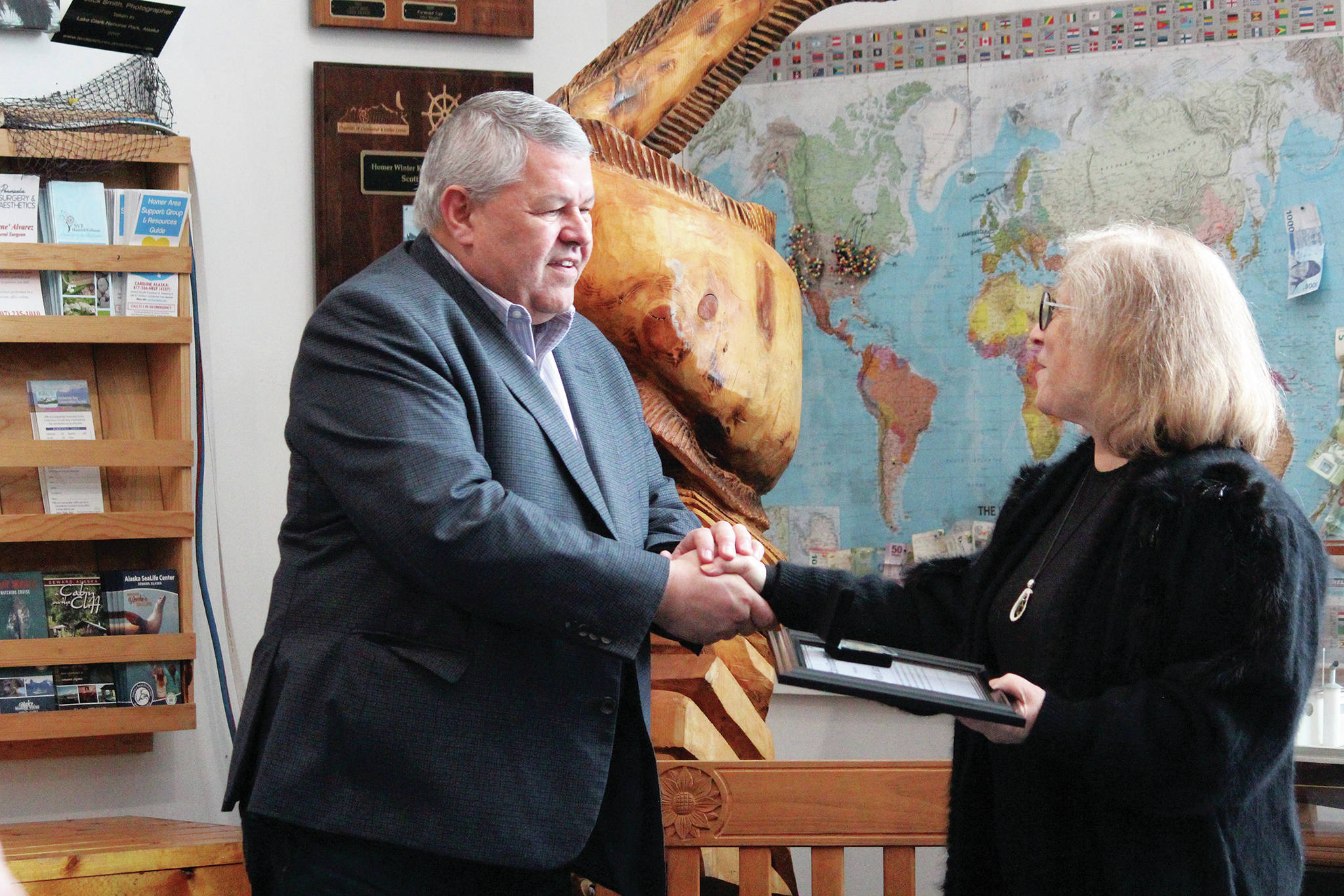 Borough Mayor Charlie Pierce presents local advocate Nona Safra with an exemplary service award Wednesday, March 10, 2021 at the Homer Chamber of Commerce & Visitor Center in Homer, Alaska. (Photo by Megan Pacer/Homer News)