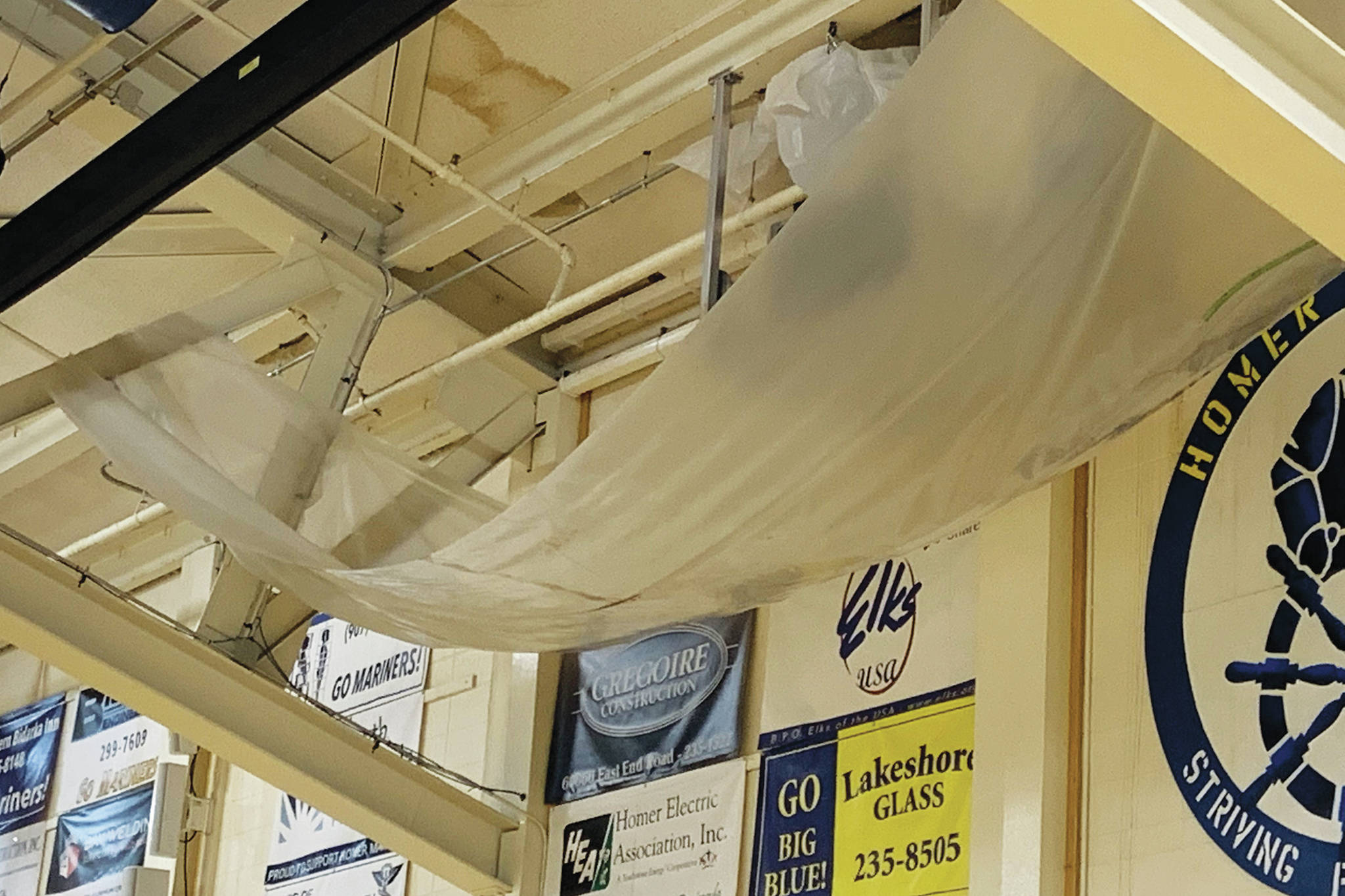 A large tarp hangs in the Homer High School gymnasium to catch water leaking through the roof at the school in Homer, Alaska. (Photo courtesy Doug Waclawski)