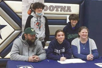 Soldotna senior Morgan Bouschor signs her National Letter of Intent on Wednesday, March 17, 2021, at Soldotna High School in Soldotna, Alaska. Bouschor is with her father, Jeffrey, her mother, Chrissy, and brothers Eli and Zack. (Photo provided)