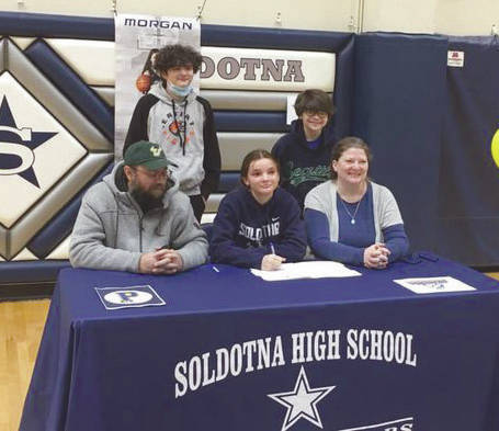 Soldotna senior Morgan Bouschor signs her National Letter of Intent on Wednesday, March 17, 2021, at Soldotna High School in Soldotna, Alaska. Bouschor is with her father, Jeffrey, her mother, Chrissy, and brothers Eli and Zack. (Photo provided)