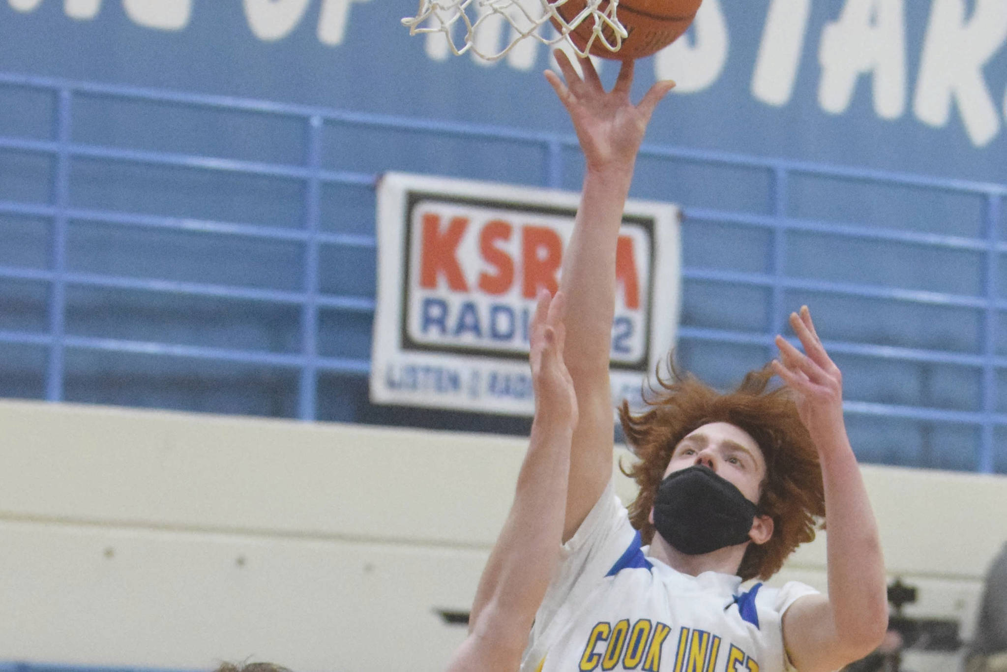 Cook Inlet Academy's Mason Zeigler goes up for a shot against Birchwood Christian's Tyler Huston at the Peninsula Conference tournament Thursday, March 18, 2021, at Soldotna High School in Soldotna, Alaska. (Photo by Jeff Helminiak/Peninsula Clarion)