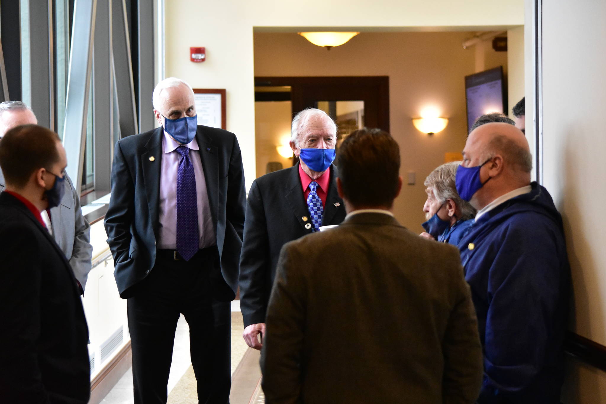 Masked House Republicans meet in the hallway of the Alaska State Capitol on Friday, March 19, 2021, to discuss Rep. Chris Kurka’s refusal to remove a controversial mask. (Peter Segall / Juneau Empire)