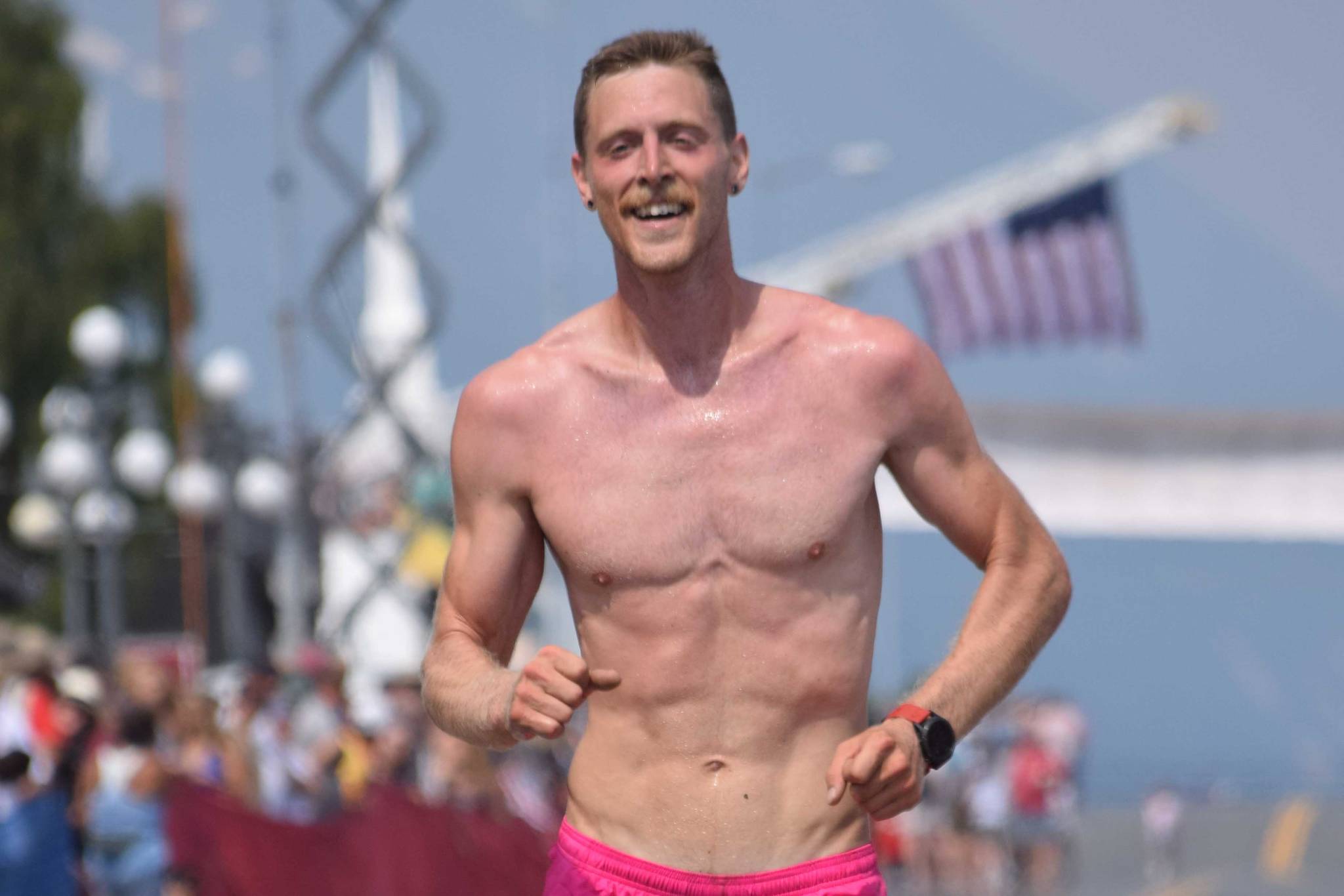 Anchorage’s Lars Arneson, a 2009 graduate of Cook Inlet Academy, finishes third in the men’s Mount Marathon Race on Thursday, July 4, 2019, in Seward, Alaska. (Photo by Jeff Helminiak/Peninsula Clarion)