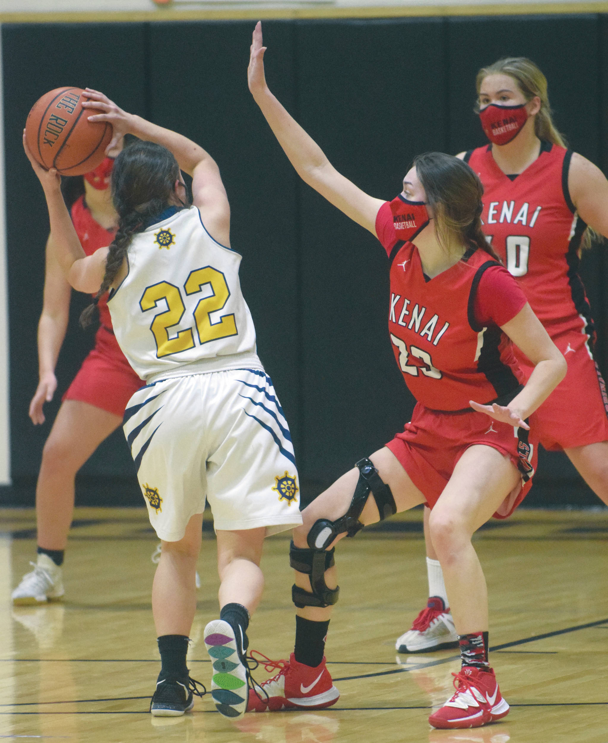 Homer’s Hannah Hatfield is defended by Kenai Central’s Logan Satathite on Friday, March 12, 2021, at the Southcentral Conference tournament at Nikiski High School in Nikiski, Alaska. (Photo by Jeff Helminiak)