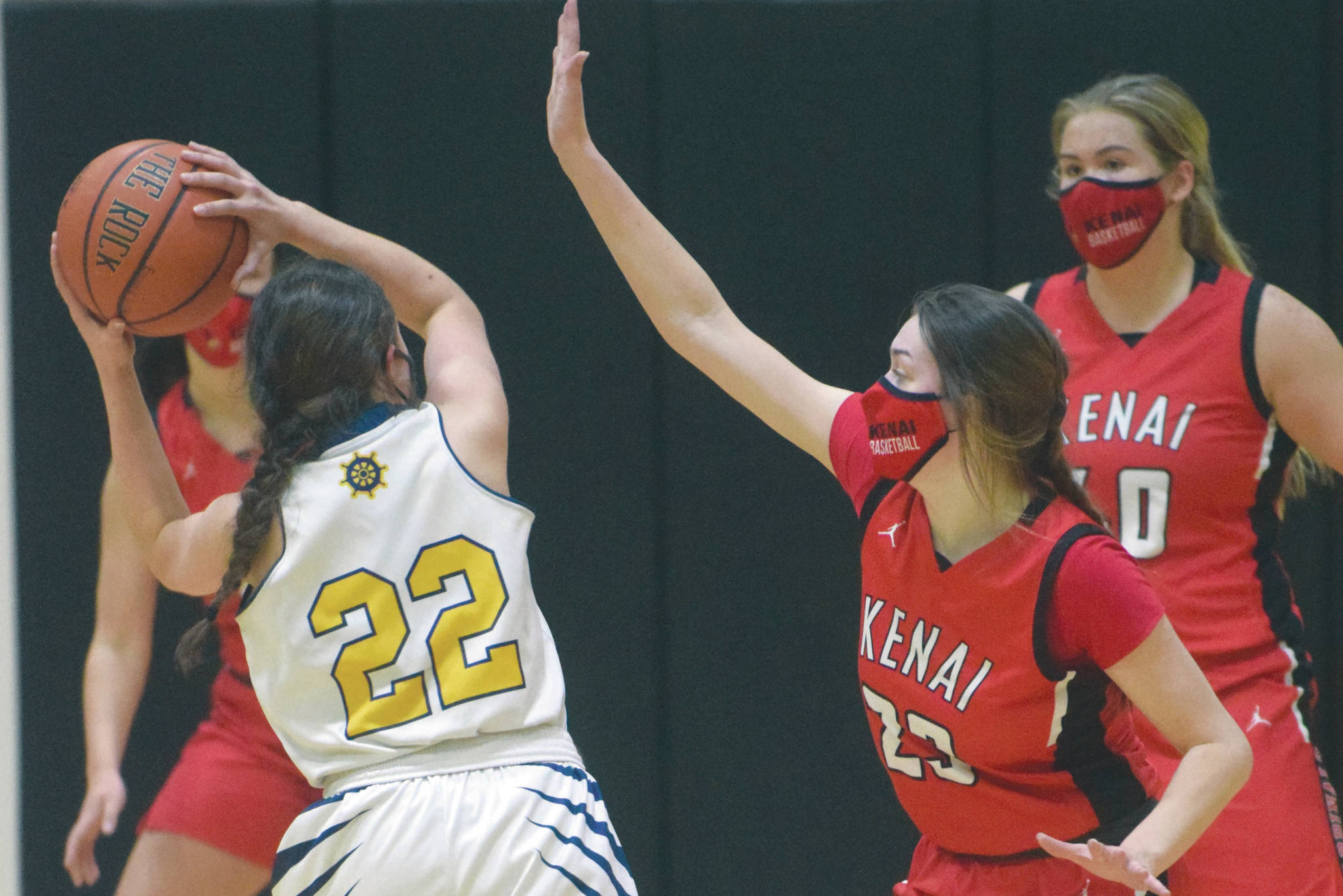 Homer's Hannah Hatfield is defended by Kenai Central's Logan Satathite on Friday, March 12, 2021, at the Southcentral Conference tournament at Nikiski High School in Nikiski, Alaska. (Photo by Jeff Helminiak)