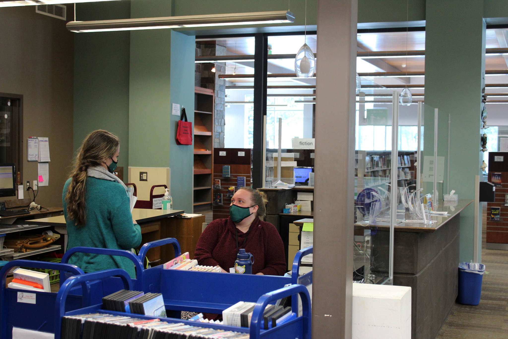 Ryanna Thurman (right) speaks to a library employee at the Soldotna Public Library on Thursday, March 25, 2021, in Soldotna, Alaska. (Ashlyn O’Hara/Peninsula Clarion)