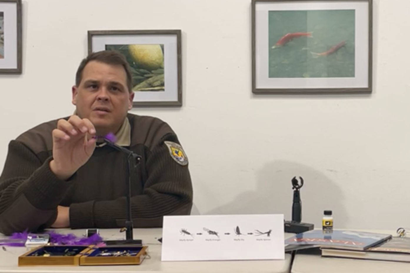 Matt Conner (left) and Amber Kraxberger-Linson demonstrate how to tie flies during a remote workshop on Friday, March 26, 2021, in Alaska. (Screenshot)