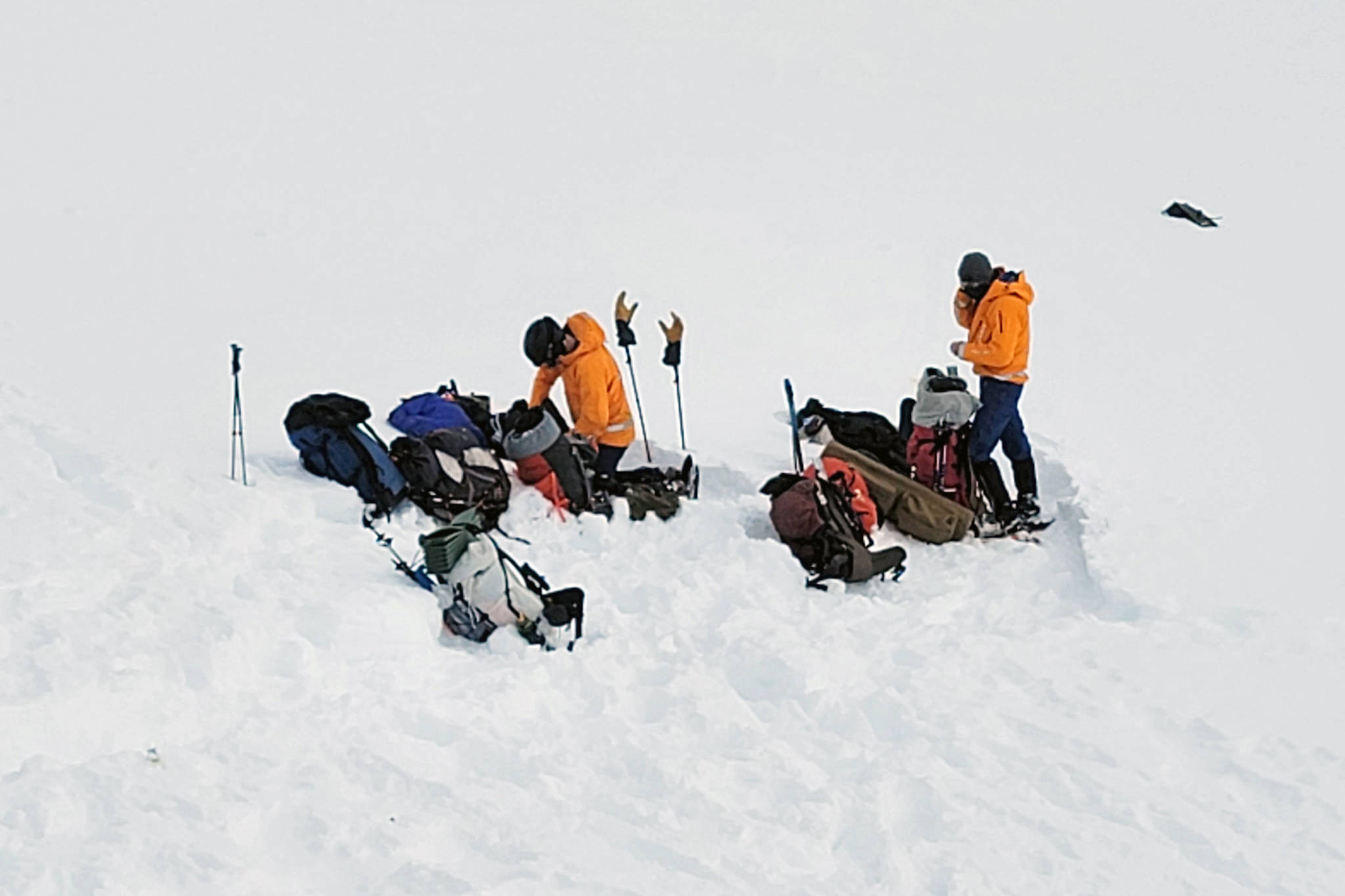In this photo provided by the Alaska Mountain Rescue Group, some of the group’s volunteers work near the scene of a helicopter crash close to the Knik Glacier in Alaska on Sunday, March 28, 2021. Federal investigators say a helicopter carrying five passengers on a heli-skiing trip in Alaska crashed into a mountain and then rolled downhill nearly 900 feet. The pilot and four of the five passengers on board died in the crash, including billionaire Petr Kellner, the richest man in the Czech Republic. The National Transportation Safety Board is investigating the cause of the crash just north of Anchorage on Saturday night. (Lance Flint/Alaska Mountain Rescue Group via AP)