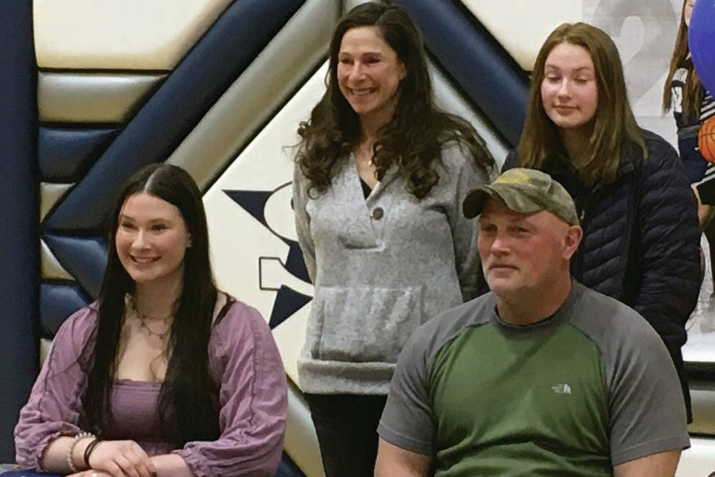 Soldotna senior Autumn Fischer signs her National Letter of Intent on Friday, March 26, 2021, at Soldotna High School in Soldotna, Alaska. Next to Autumn is her father, Eric Fischer. In the back row is mother, Judith Fischer, and sister, Brook Fischer. (Photo provided)