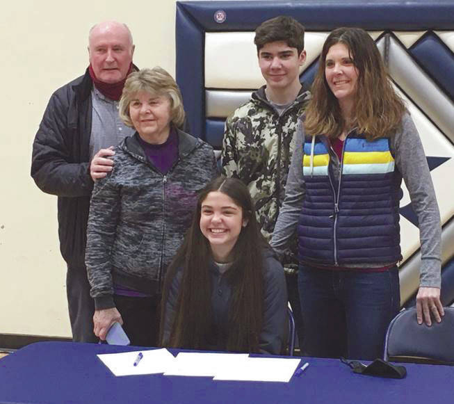 Erika Arthur signs her National Letter of Intent on Tuesday, March 30, 2021, at Soldotna High School in Soldotna, Alaska. Behind her are grandparents, Mike and Gloria Sweeney; brother, Andrew Arthur; and mother, Krista Arthur. (Photo provided)