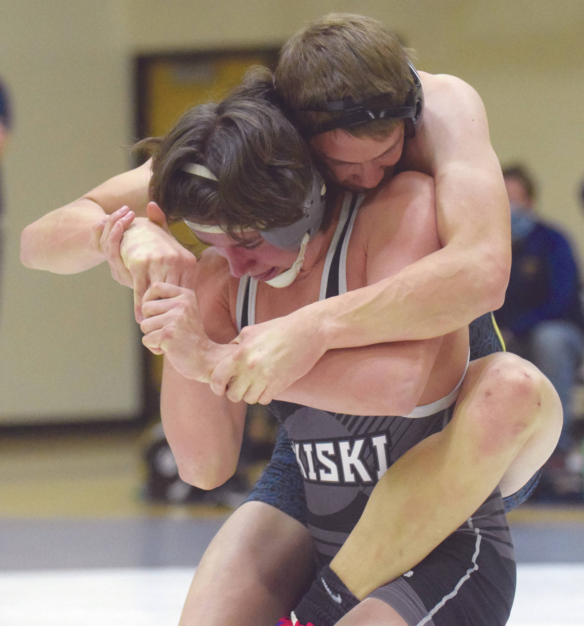 Homer’s Nestor Kalugin tries to control Nikiski’s Simon Grenier at 171 pounds Tuesday, March 30, 2021, at Nikiski High School in Nikiski, Alaska. Grenier won by 10-4 decision. (Photo by Jeff Helminiak/Peninsula Clarion)