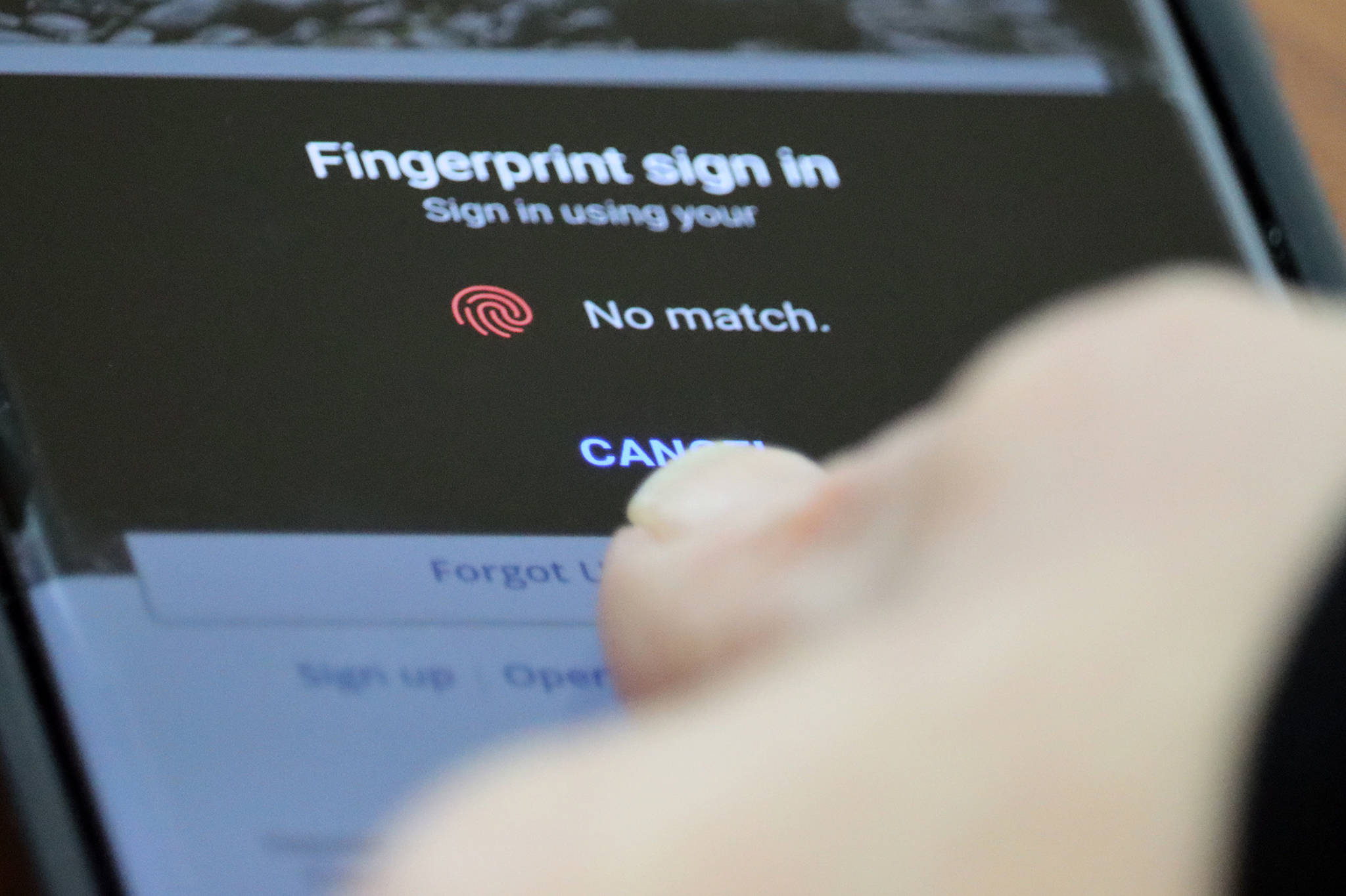 A person holds their thumb over a fingerprint sensor to log into an application. Gov. Mike Dunleavy on Wednesday introduced a bill that would make companies that collect and sell private information have to receive user's consent first. (Ben Hohenstatt / Juneau Empire)