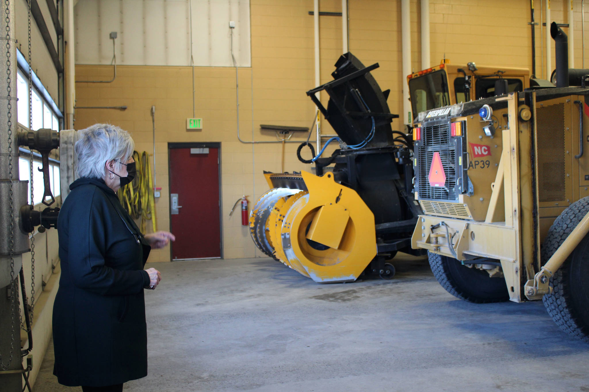 Mary Bondurant walks inside of a storage facility at Kenai Municipal Airport on Monday, April 5 in Kenai, Alaska. (Ashlyn O’Hara/Peninsula Clarion)