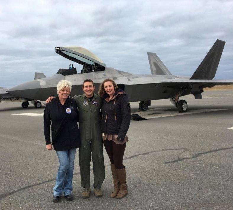 Mary Bondurant (left) and her assistant Erica Brincefield (right) stand with an F22 pilot in front of the first F22 to land at Kenai Municipal Airport. (Photo courtesy Mary Bondurant)