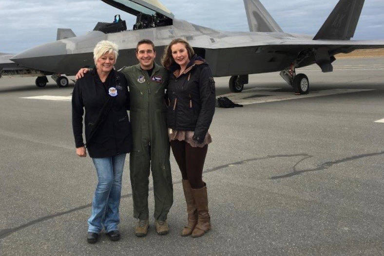 Mary Bondurant (left) and her assistant Erica Brincefield stand with an F22 pilot in front of the first F22 to land at Kenai Municipal Airport. (Photo courtesy Mary Bondurant)
