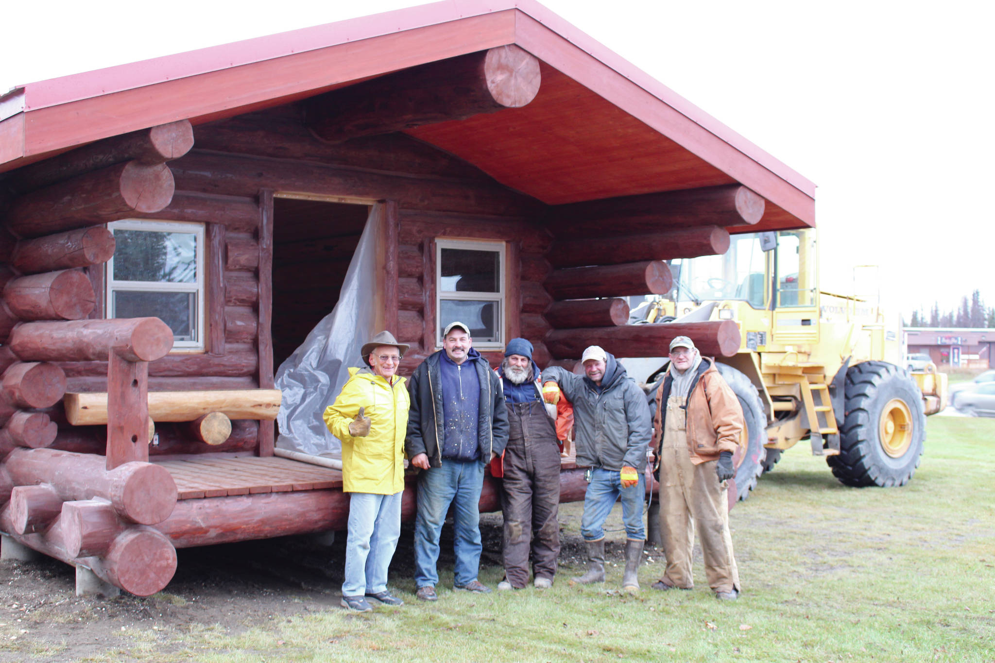 From left, Dr. Peter Hansen, Arnie Sullenger, Darrell Hamby, Tim McGahan and Andrew Conwell stand in front of the new Kenai Bush Doctor’s Historic Cabin on Nov. 13, 2019. Hansen died March 25, 2021. (Photo by Brian Mazurek/Peninsula Clarion)