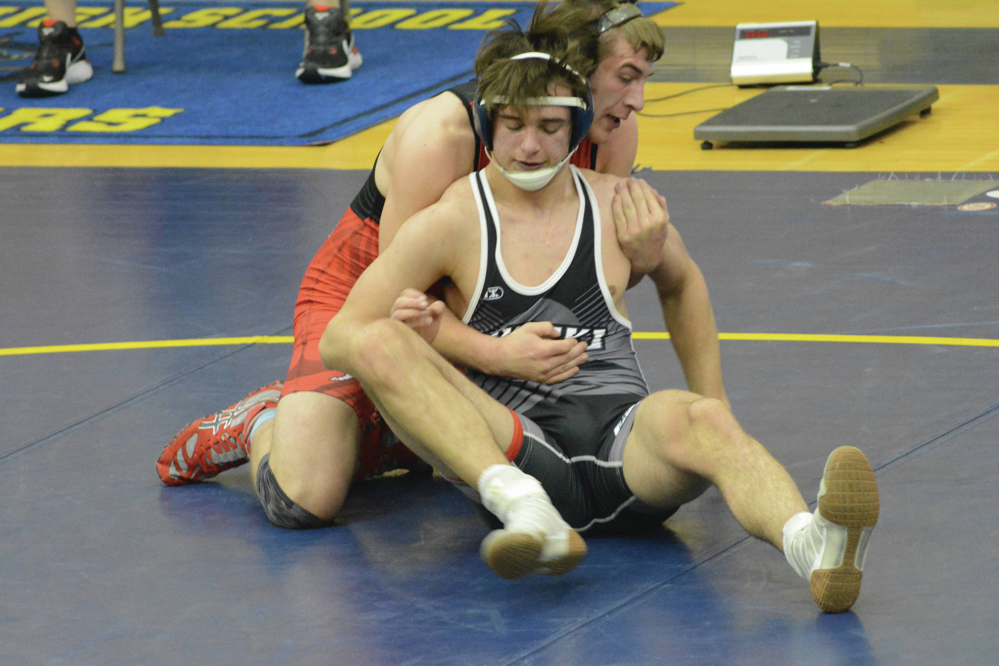 Kardinal Tucker Vann wrestles Bulldog Caileb Payne in a meet on Tuesday, April 6, 2021, in the Alice Witte Gym at Homer High School in Homer, Alaska. (Photo by Michael Armstrong/Homer News)