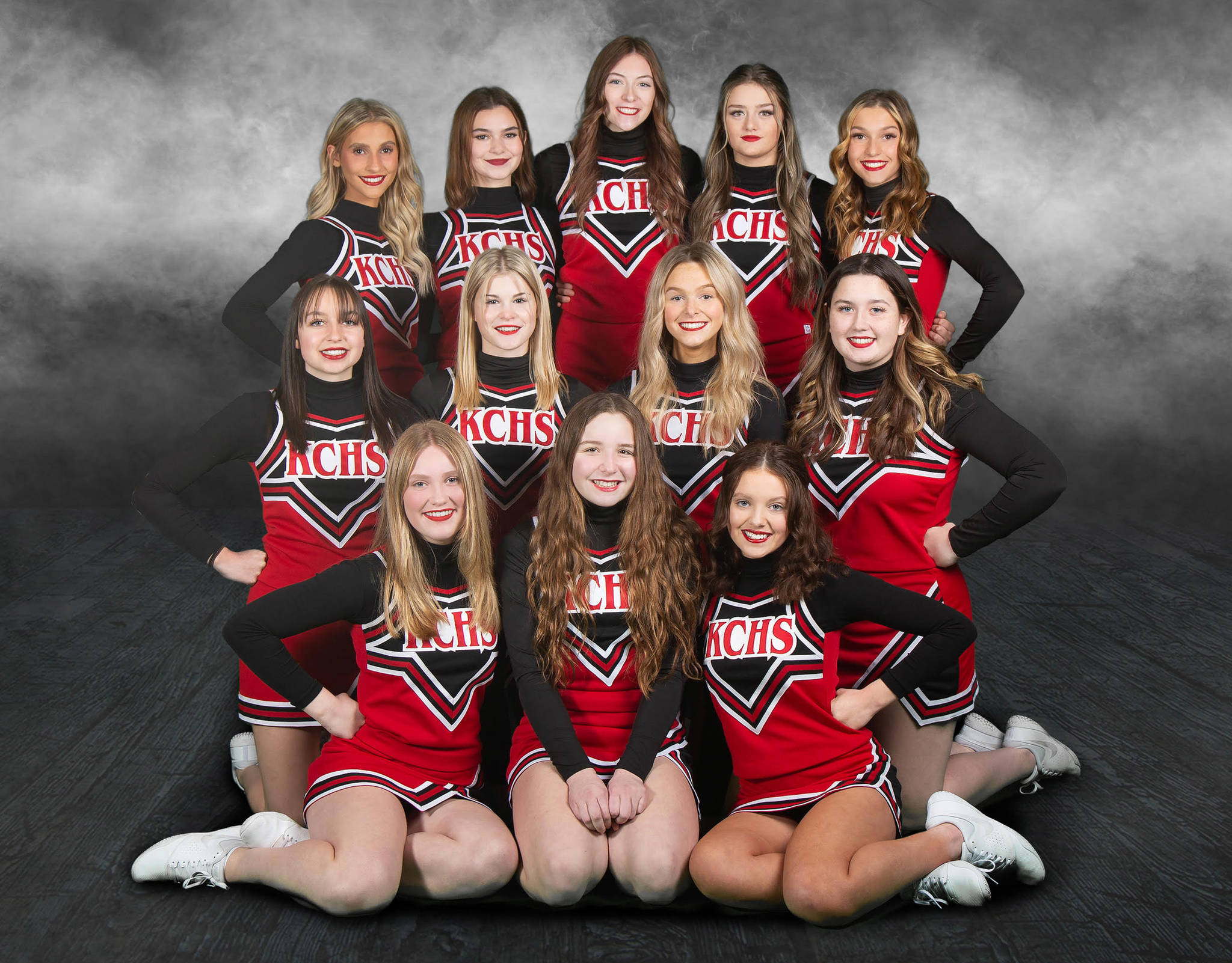 The Kenai Central high school cheerleading team. Back row, left to right: Karley Harden, Nia Calvert, Katie Stockton, Rileigh Pace and Kyrie Medina. Middle row: Karah Huff, Melena Grieme, Calani Holmes and Maya Montague. Front row: Emmalee Roney, Kaitlyn Taylor and Kori Moore. (Photo courtesy of Rebecca Beddow of BeKaptured Photography)