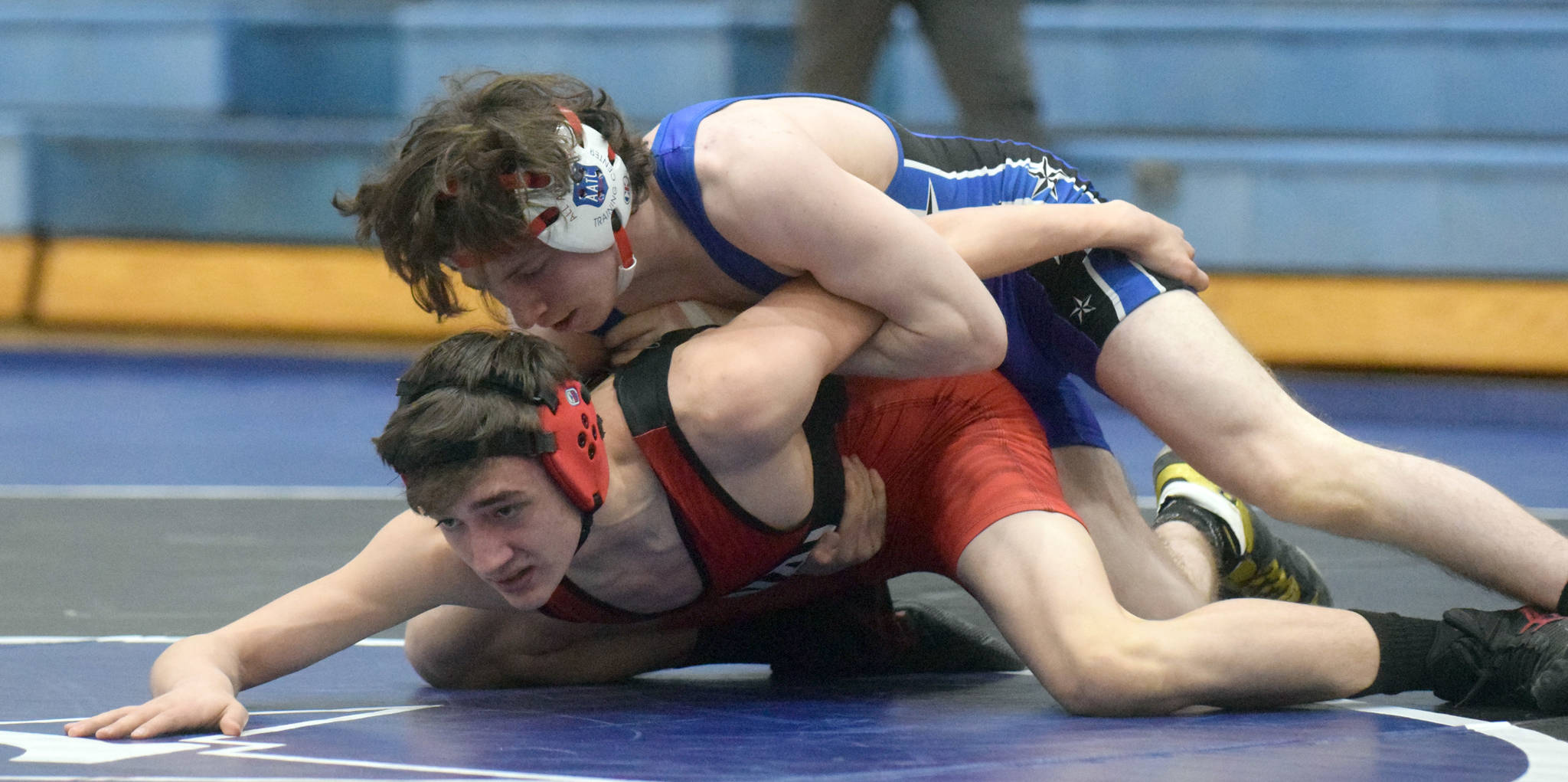 Soldotna’s Ezekiel Miller controls Kenai Central’s Owen Whicker at 130 pounds Friday, April 9, 2021, at Soldotna High School in Soldotna, Alaska. Miller won by major decision, 11-1. (Photo by Jeff Helminiak/Peninsula Clarion)