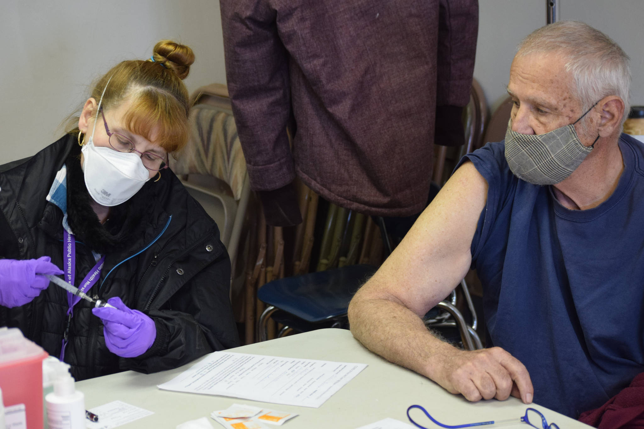 Public Health Nurse Andrea Hooper prepares to administer the Janssen COVID-19 vaccine to Denny Thomas at the United Methodist Church in Kenai, Alaska on Monday, April 12, 2021. Public Health teamed up with the church to offer vaccines during its weekly food distribution event.