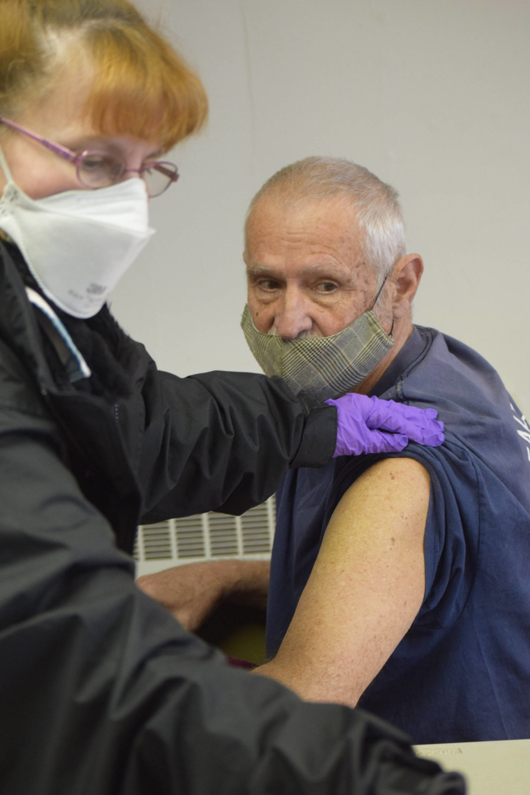 Public Health Nurse Andrea Hooper discards the needle after administering the Janssen COVID-19 vaccine to Denny Thomas at the United Methodist Church in Kenai, Alaska on Monday, April 12, 2021. Public Health teamed up with the church to offer vaccines during its weekly food distribution event.