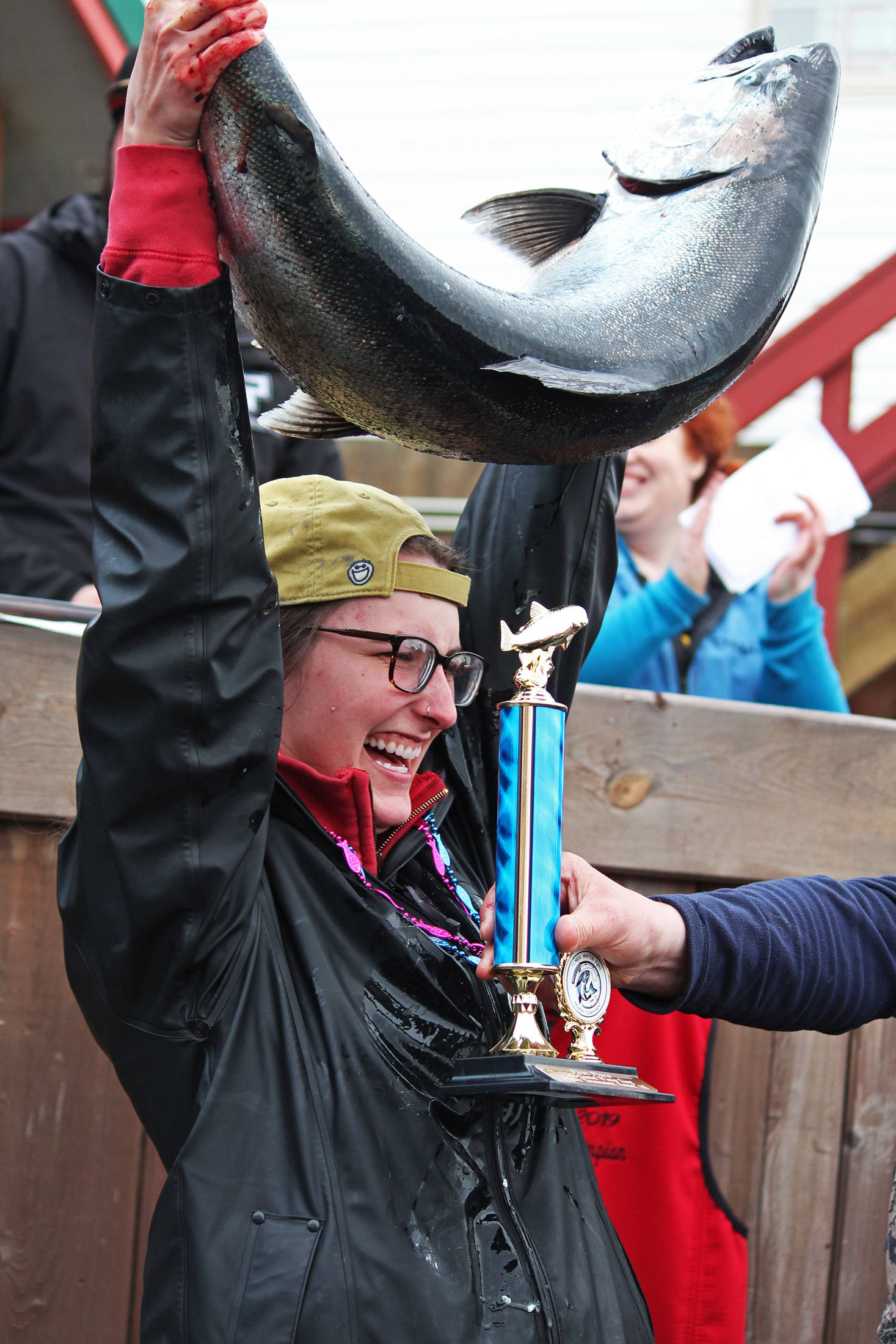 Shayna Perry, of Eagle River, holds up her winning 26.7-pound white salmon at the award ceremony following the Homer Winter King Salmon Tournament on March 23, 2019 at Coal Point Seafoods in Homer, Alaska. Perry, who also won the award for largest white salmon, was the first woman to win the annual tournament. (Photo by Megan Pacer/Homer News)