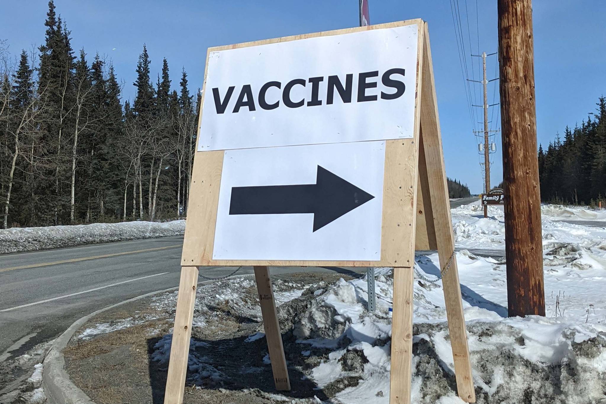 A sign is posted directing drivers to a vaccine clinic held at Beacon Occupational Health in Kenai, Alaska, on Saturday, April 10, 2021. (Photo by Erin Thompson/Peninsula Clarion)