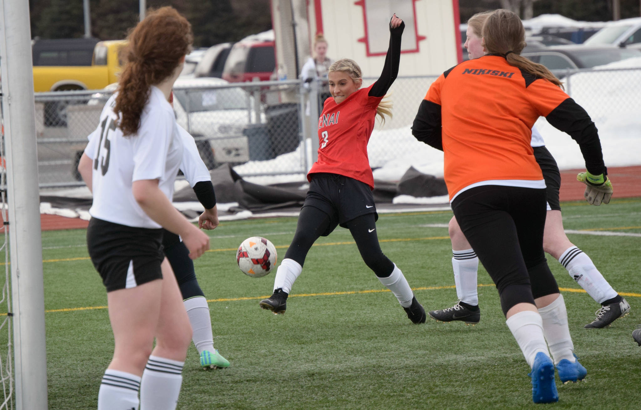 Kenai Central’s Karley Harden attacks the Nikiski net Thursday, April 15, 2021, at Kenai Central High School in Kenai, Alaska. (Photo by Jeff Helminiak/Peninsula Clarion)