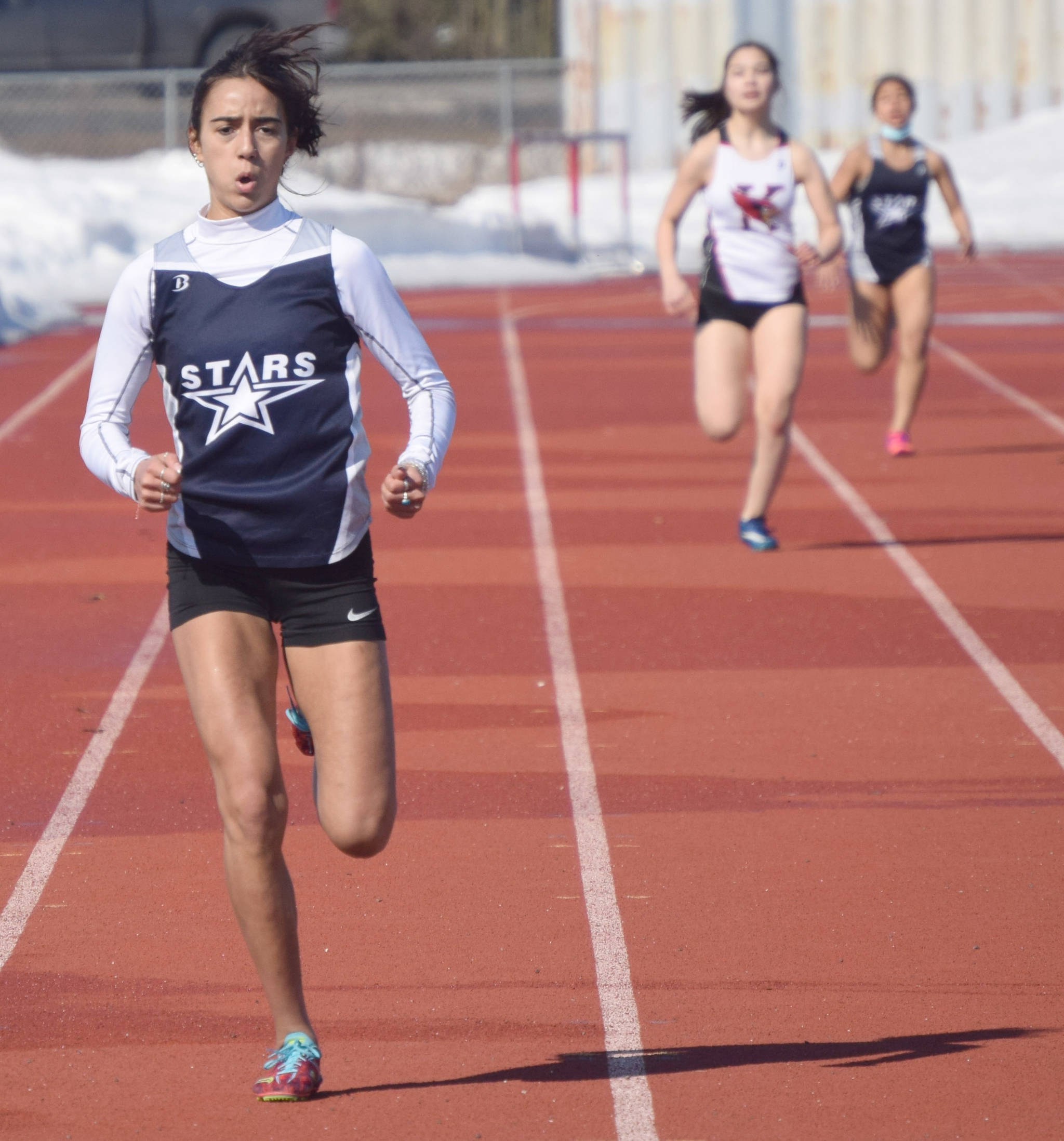 Soldotna’s Drysta Crosby-Schneider runs to victory in 400 meters in a dual meet with Kenai Central on Friday, April 16, 2021, at Kenai Central High School in Kenai, Alaska. (Photo by Jeff Helminiak/Peninsula Clarion)