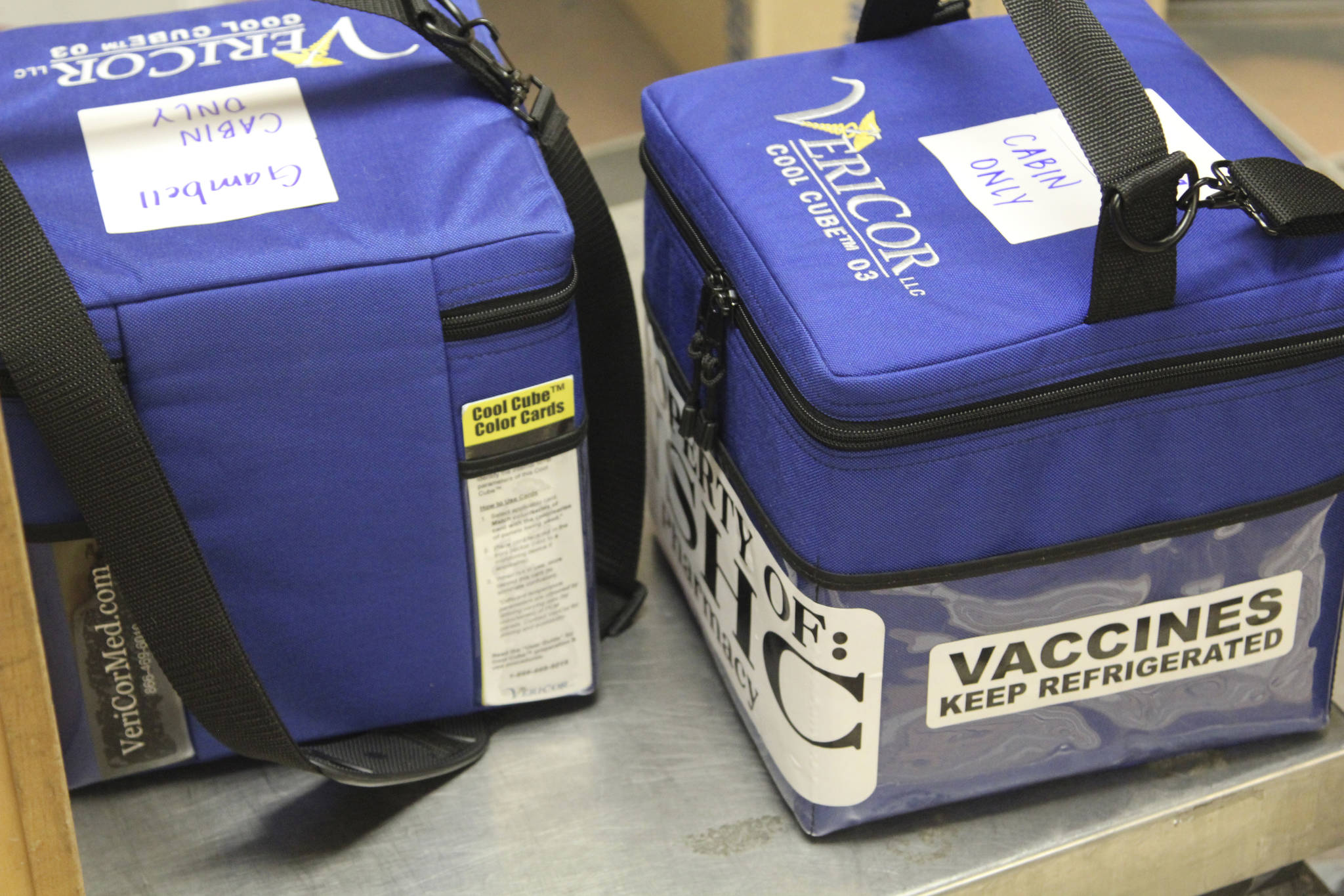 In this photo provided by Norton Sound Health Corp., are coolers containing Pfizer COVID-19 vaccines for the rural Alaska communities of Savoonga and Gambell being weighed at an air terminal in Nome, Alaska, on Jan. 14, 2021. Some of Alaska’s highest vaccination rates among those 16 or older have been in some of its remotest, hardest-to-access communities, where the toll of past flu or tuberculosis outbreaks hasn’t been forgotten. (Reba Lean/Norton Sound Health Corp. via AP)