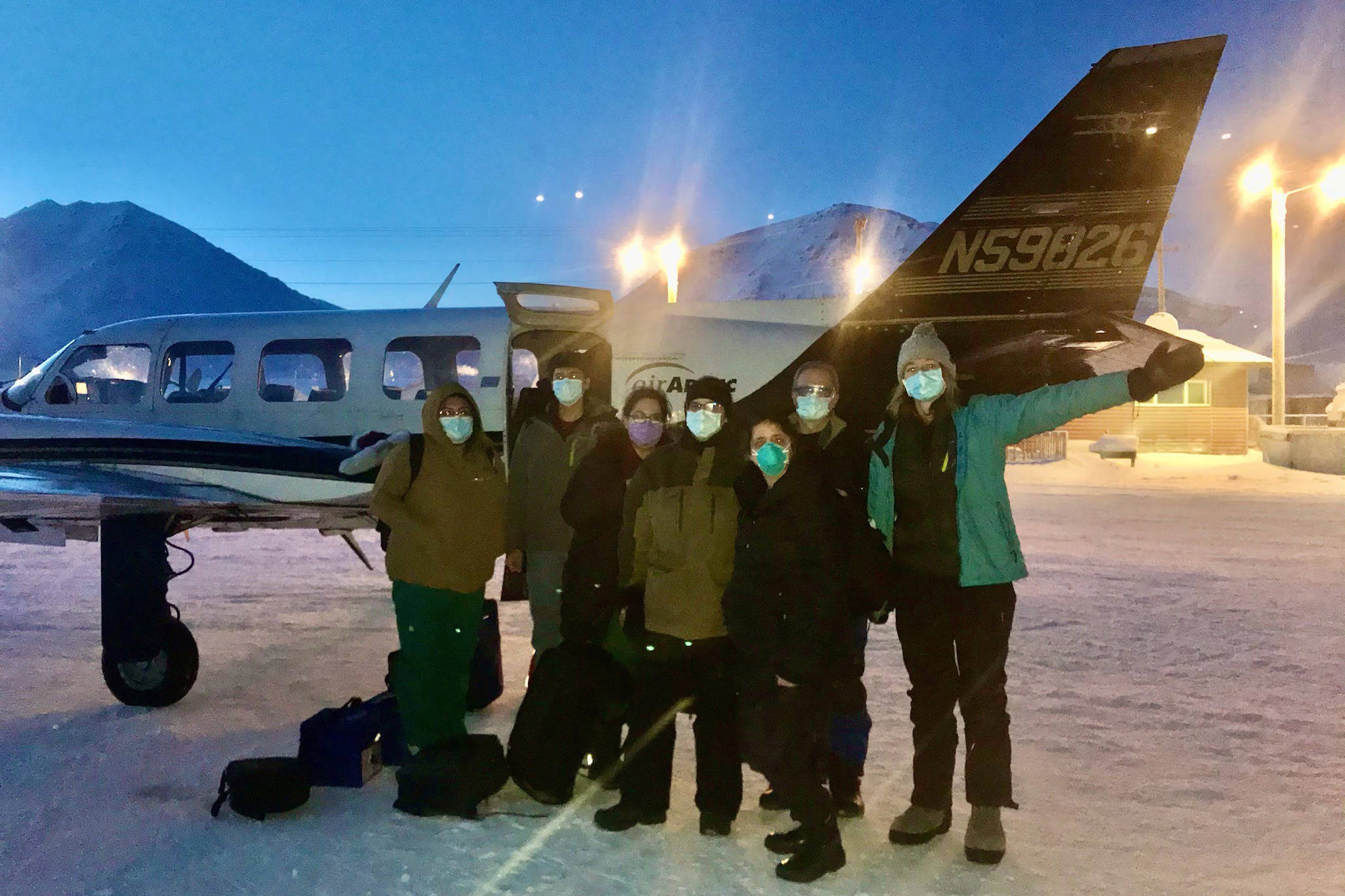 In this undated photo, provided by the Tanana Chiefs Conference, shows a team from the tribal health organization posing outside a plane before leaving for a rural vaccination clinic in Anaktuvuk Pass, Alaska. Some of Alaska’s highest vaccination rates among those 16 or older have been in some of its remotest, hardest-to-access communities, where the toll of past flu or tuberculosis outbreaks hasn’t been forgotten. (Tanana Chiefs Conference via AP)