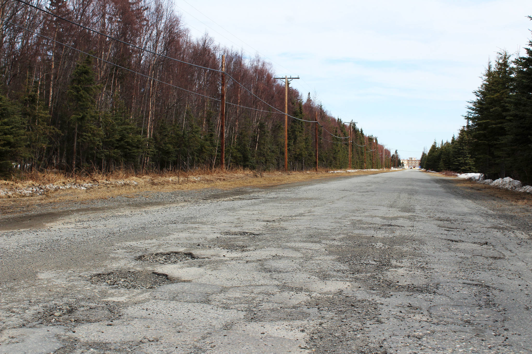 Potholes are seen on Wildwood Drive on Thursday, April 22 in Kenai, Alaska. (Ashlyn O’Hara/Peninsula Clarion)